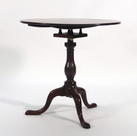 A George III mahogany supper table, the circular top on a birdcage mechanism,