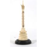 A 19th century ivory thermometer modelled as a tower on an ebonised plinth, h.
