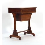 A late Victorian walnut sewing table on straight supports joined by a stretcher, w.