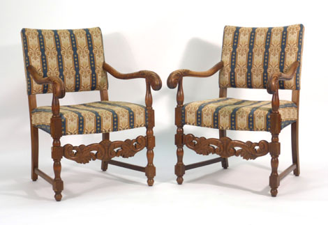 A pair of 17th century-type oak and upholstered hall armchairs with carved stretchers