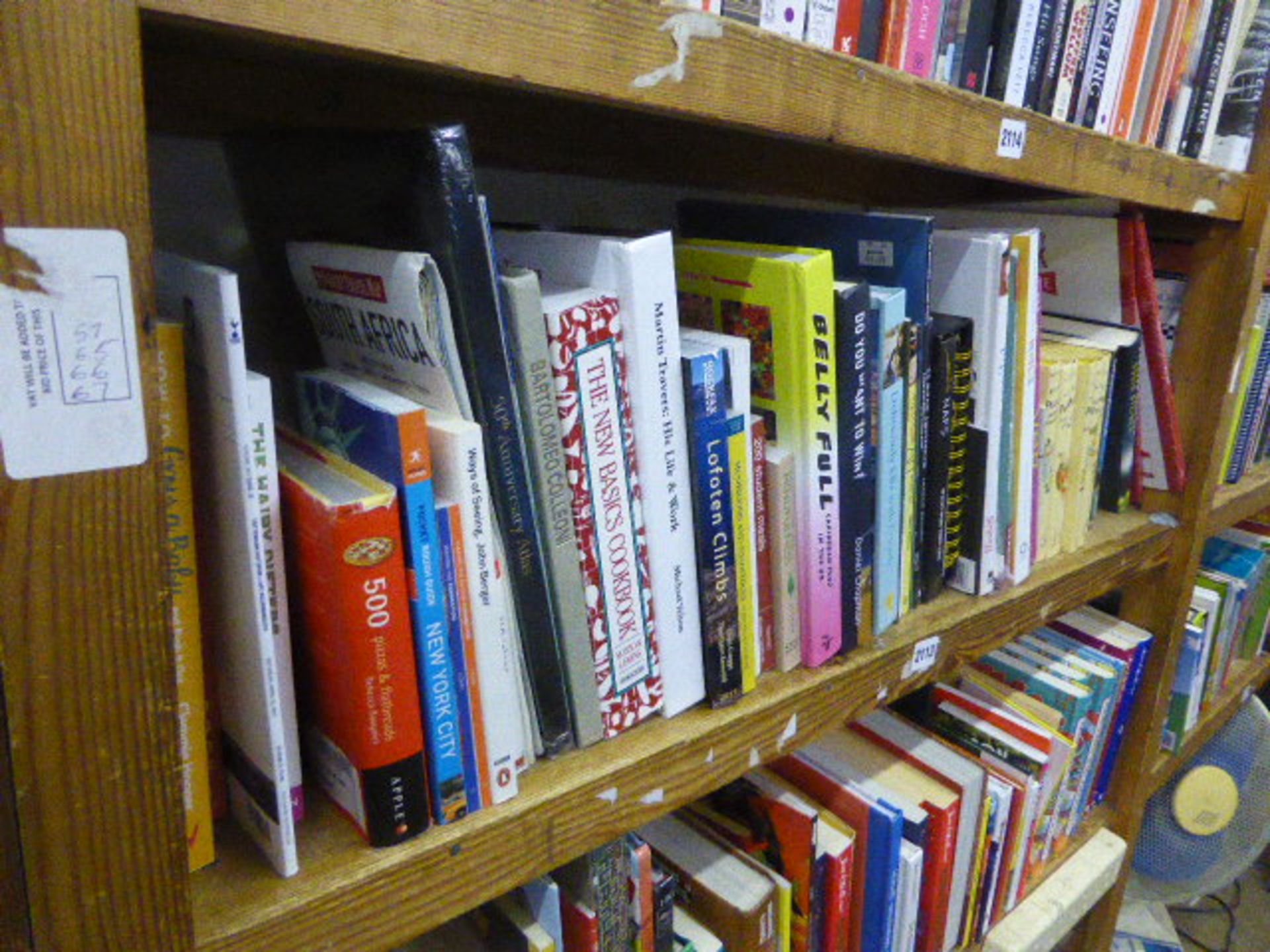 Shelf of books about cooking, travelling, etc