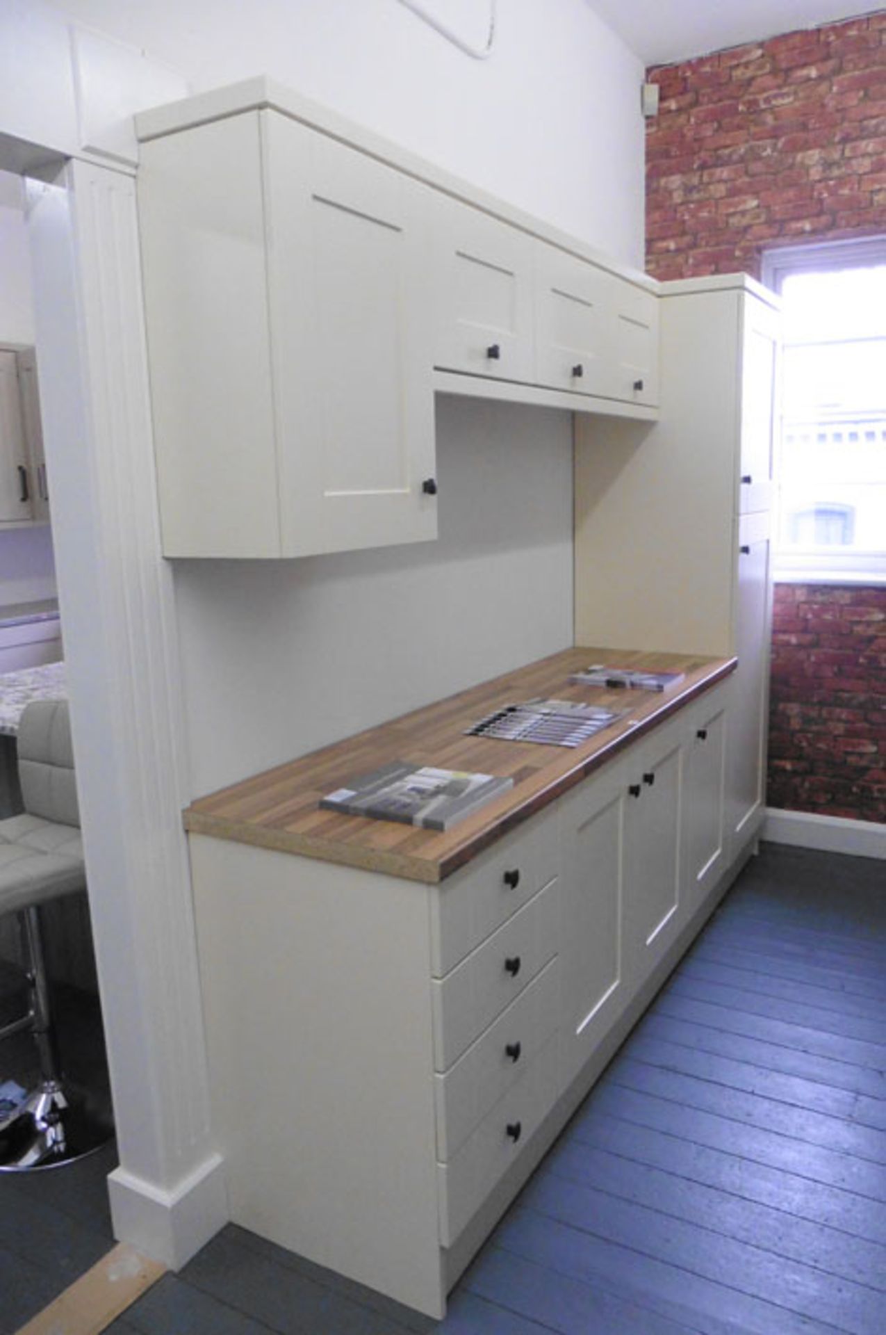 Buttercup cream shaker-style kitchen display with a wood-effect worktop, approximate width: 261 cm