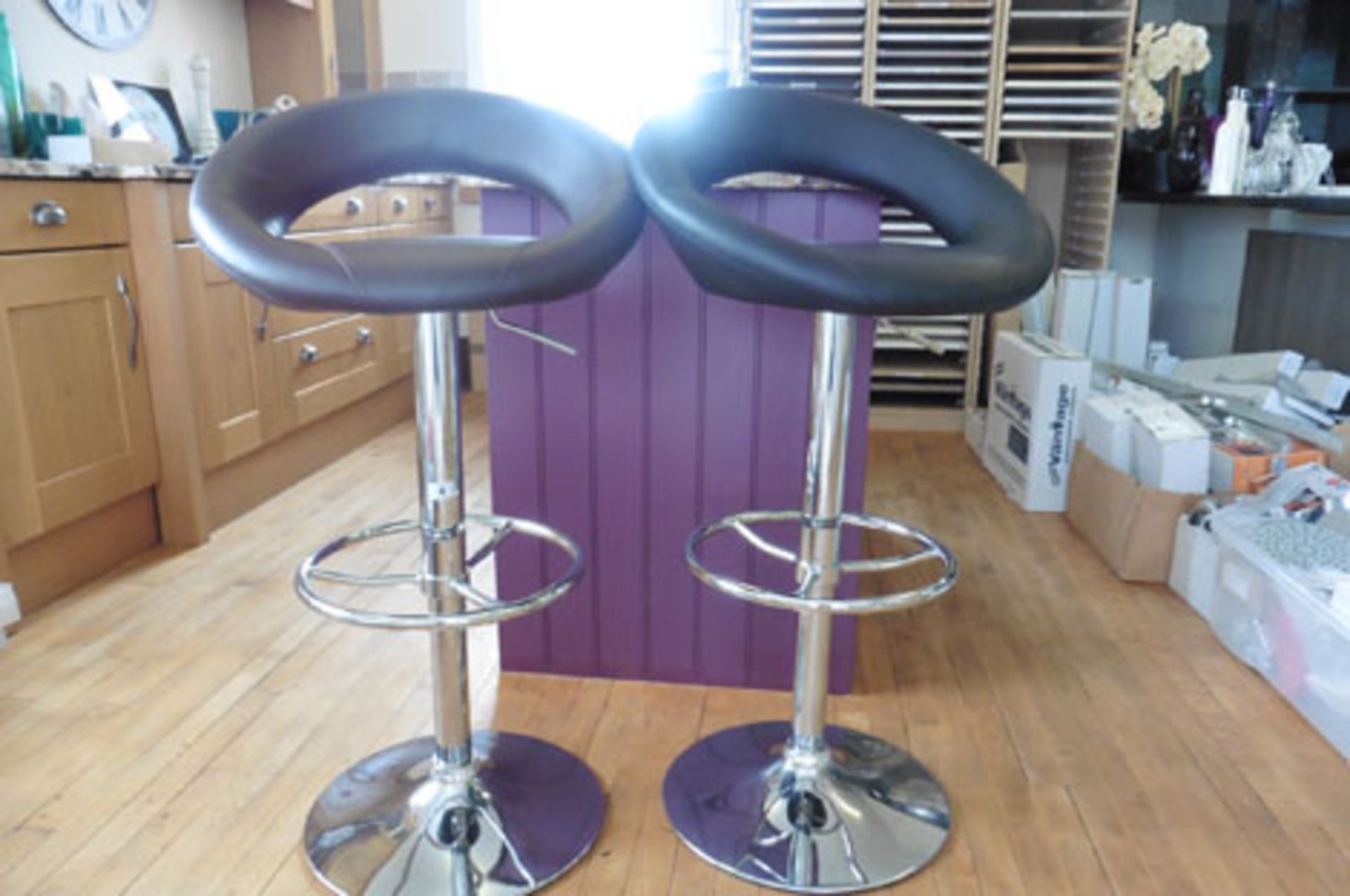 2 leather upholstered and chrome based bar stools with adjustable height (1 chocolate, 1 black)