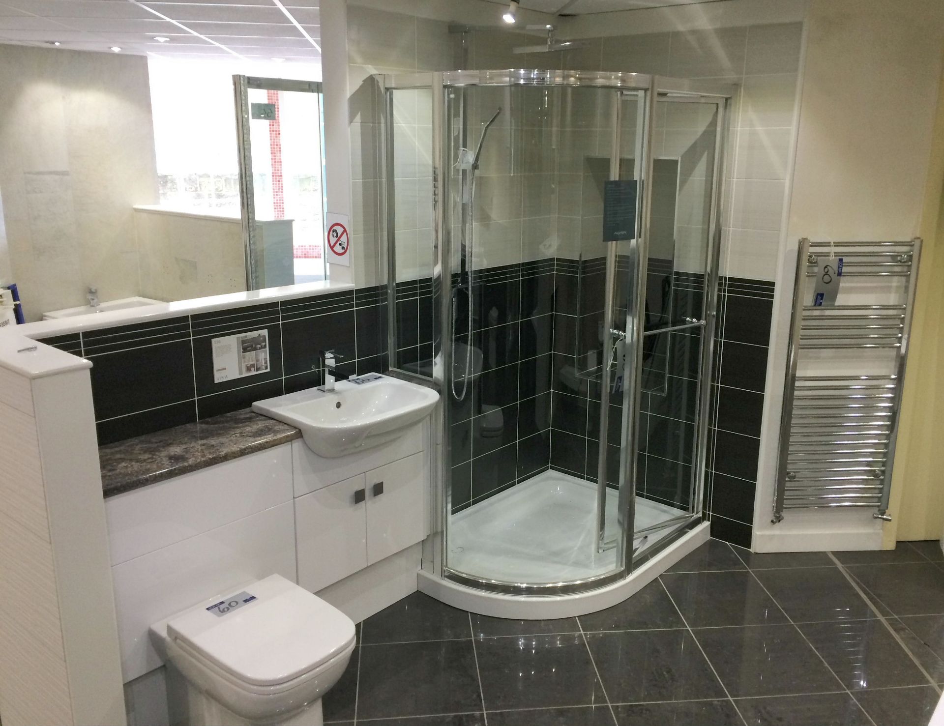 A Bathroom Display comprising Aqata Quad Bespoke Clear Glass and Chrome Hinged Door Curved Shower