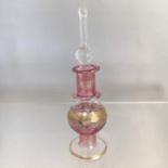 GLASS EGYPTIAN PERFUME BOTTLE. Measures 9cm including stopper.