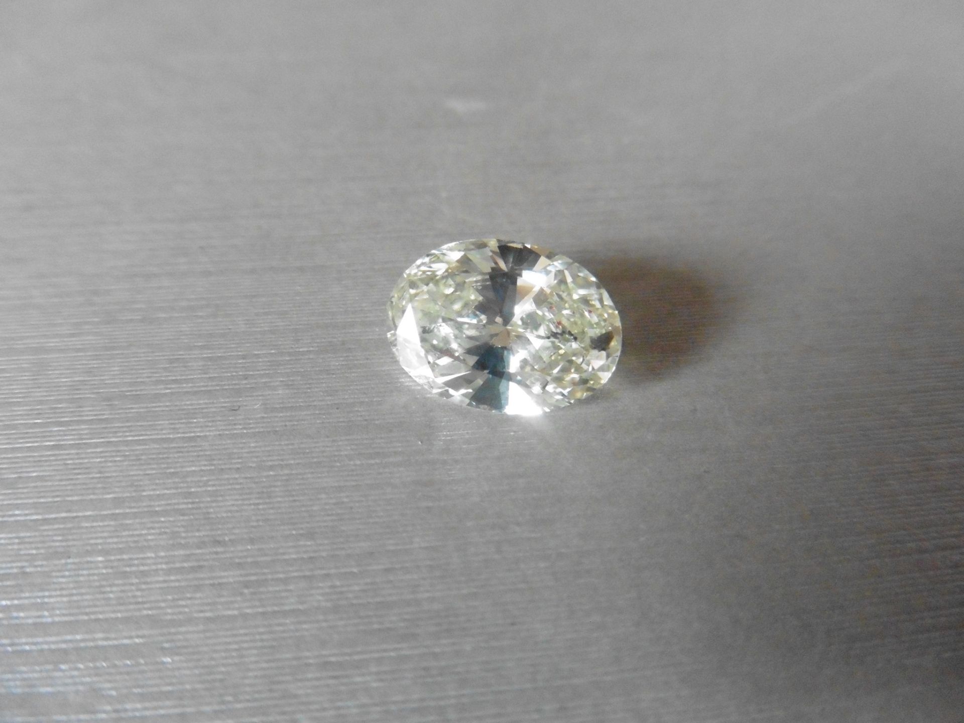 6.05ct single oval cut diamond. Measures 14.44 x 10.33 x 6.17mm. K-L colour, Si clarity.