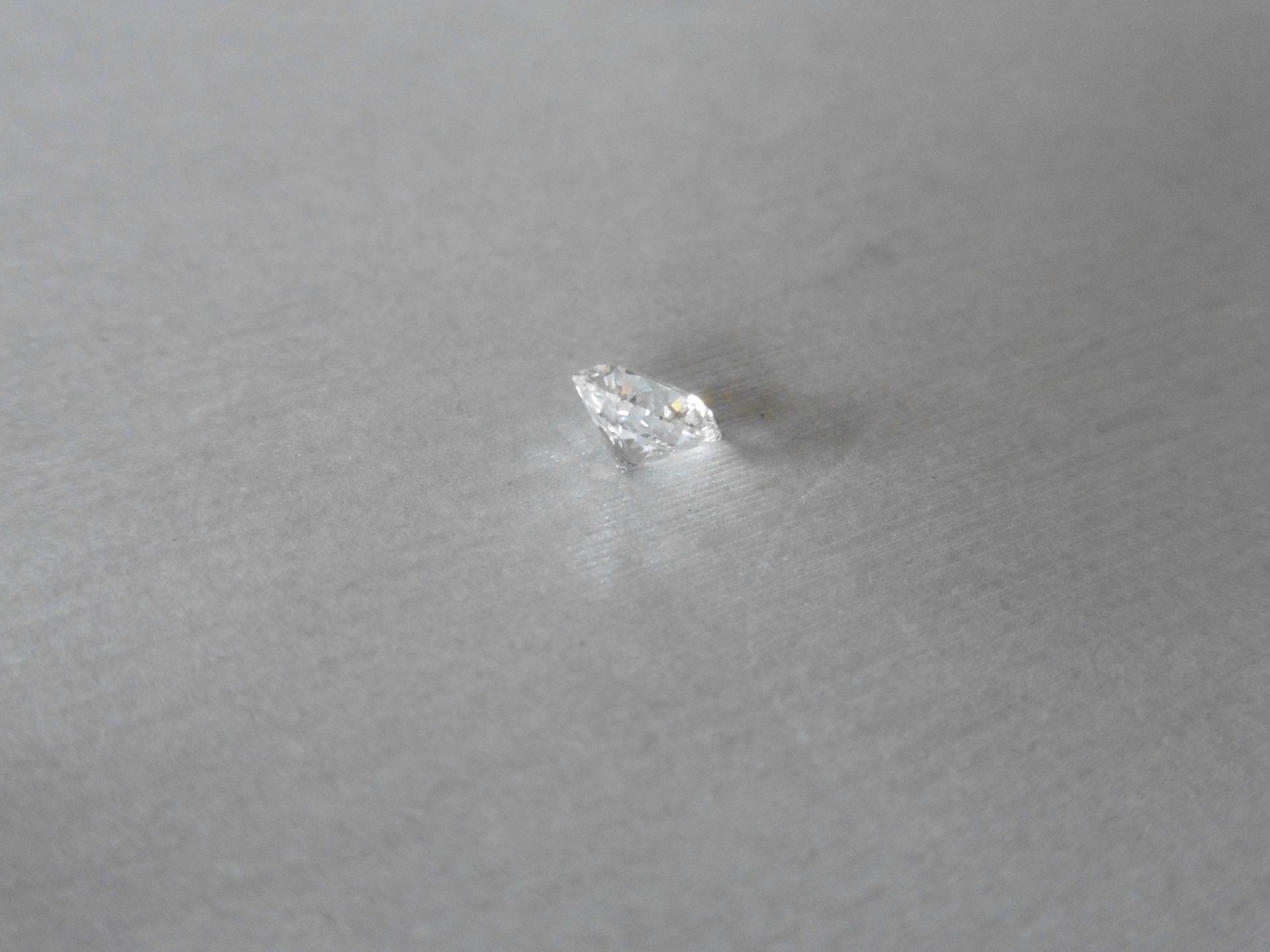 1.06ct single brilliant cut diamond, H colour SI1 clarity. 6.51mm x 6.55mm x 4.05mm.