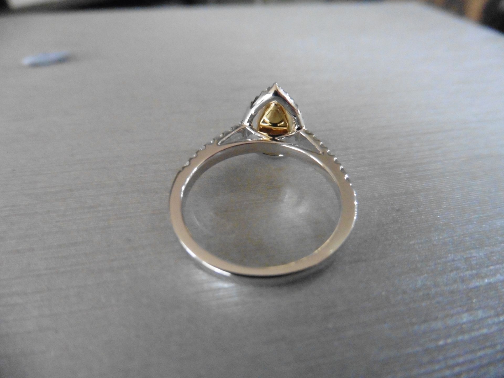 0.75ct yellow pear shaped diamond set solitaire ring. Has a halo setting of small brilliant cut - Image 2 of 5