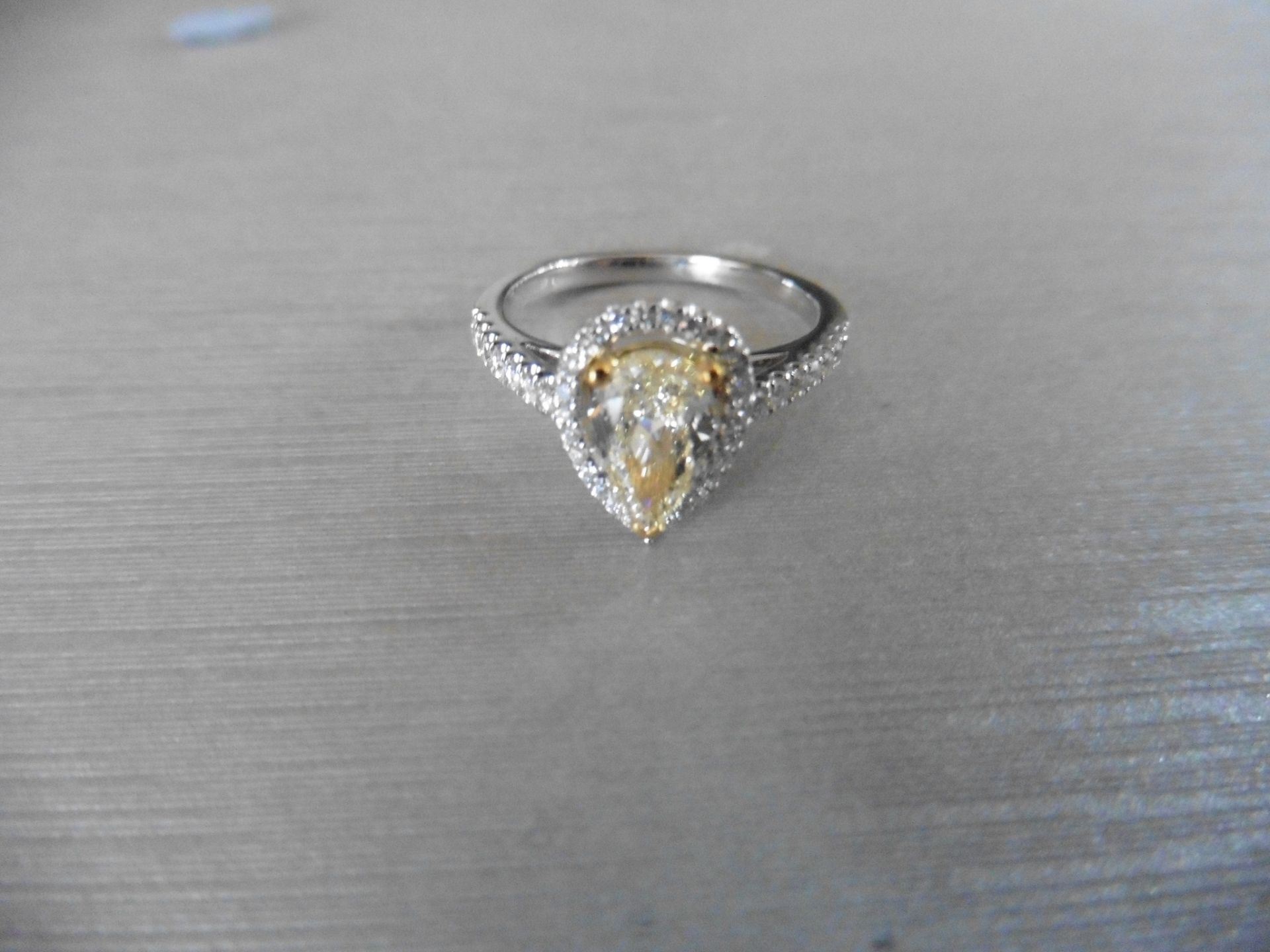 0.75ct yellow pear shaped diamond set solitaire ring. Has a halo setting of small brilliant cut - Image 3 of 5