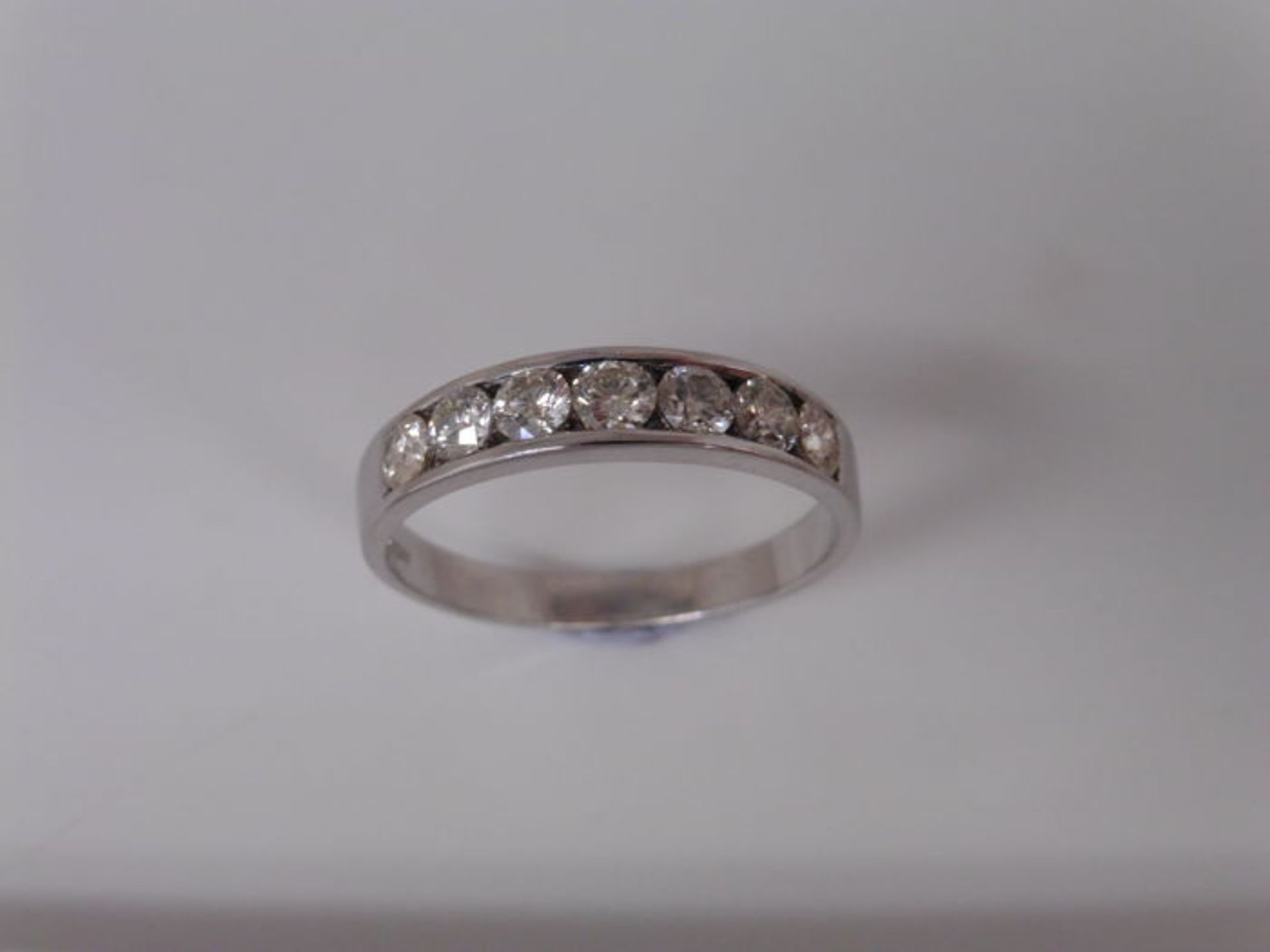 0.70ct diamond band ring set with 7 brilliant cut diamonds in a channel setting. H/I colour and - Image 3 of 4