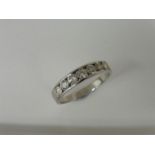 0.70ct diamond band ring set with 7 brilliant cut diamonds in a channel setting. H/I colour and