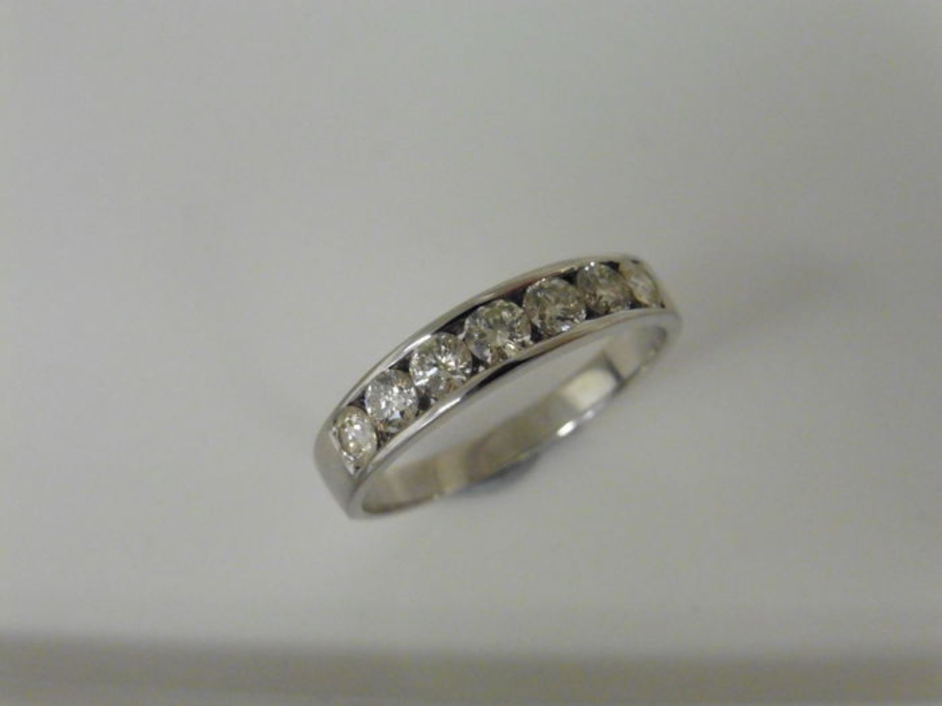 0.70ct diamond band ring set with 7 brilliant cut diamonds in a channel setting. H/I colour and