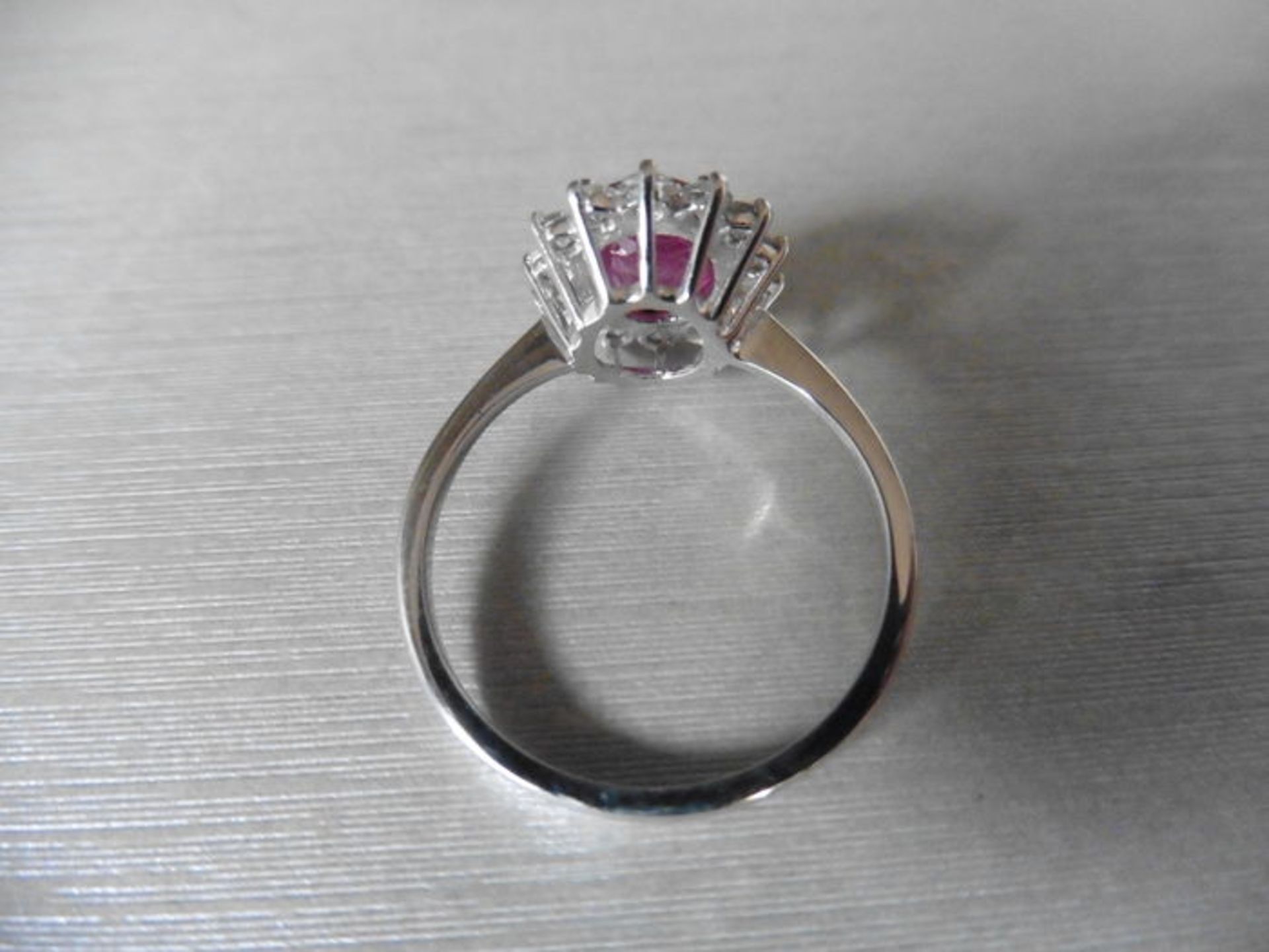 Ruby and diamond cluster style ring set in platinum. Oval cut ( glass filled ) ruby 2.50ct with 0. - Image 2 of 3