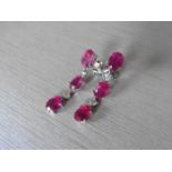 4.80ct ruby and diamond drop earrings set in platinum. Each set with 3 oval cut rubies ( glass
