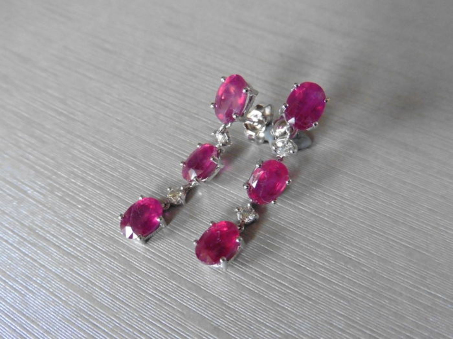 4.80ct ruby and diamond drop earrings set in platinum. Each set with 3 oval cut rubies ( glass