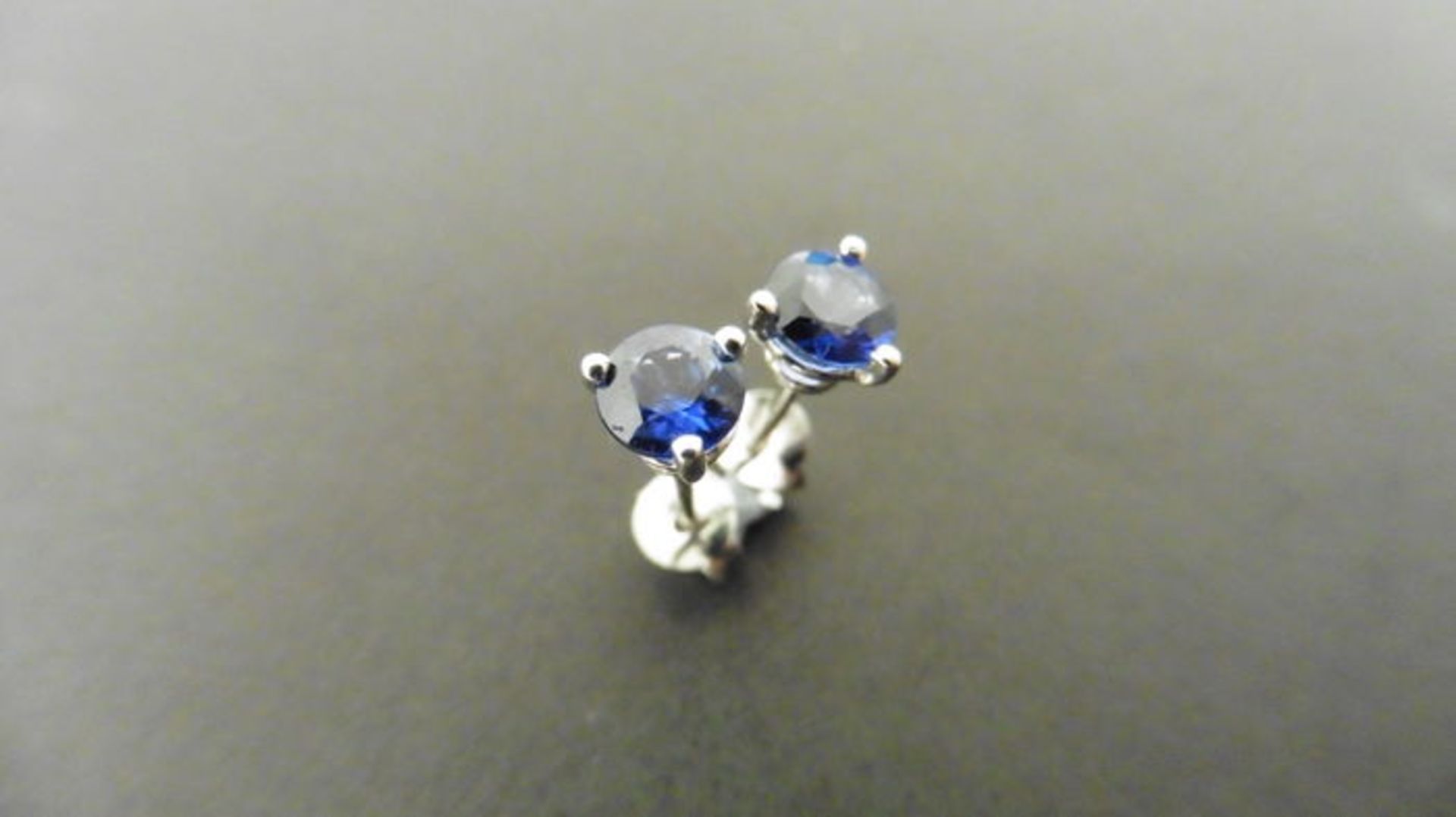 1ct solitaire stud style earrings set with round cut sapphires ( treated ) weighing approx 1.00ct. 3