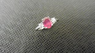 Ruby and diamond trilogy ring. 7 x 5mm oval ruby ( glass filled ) with a brilliant cut diamond