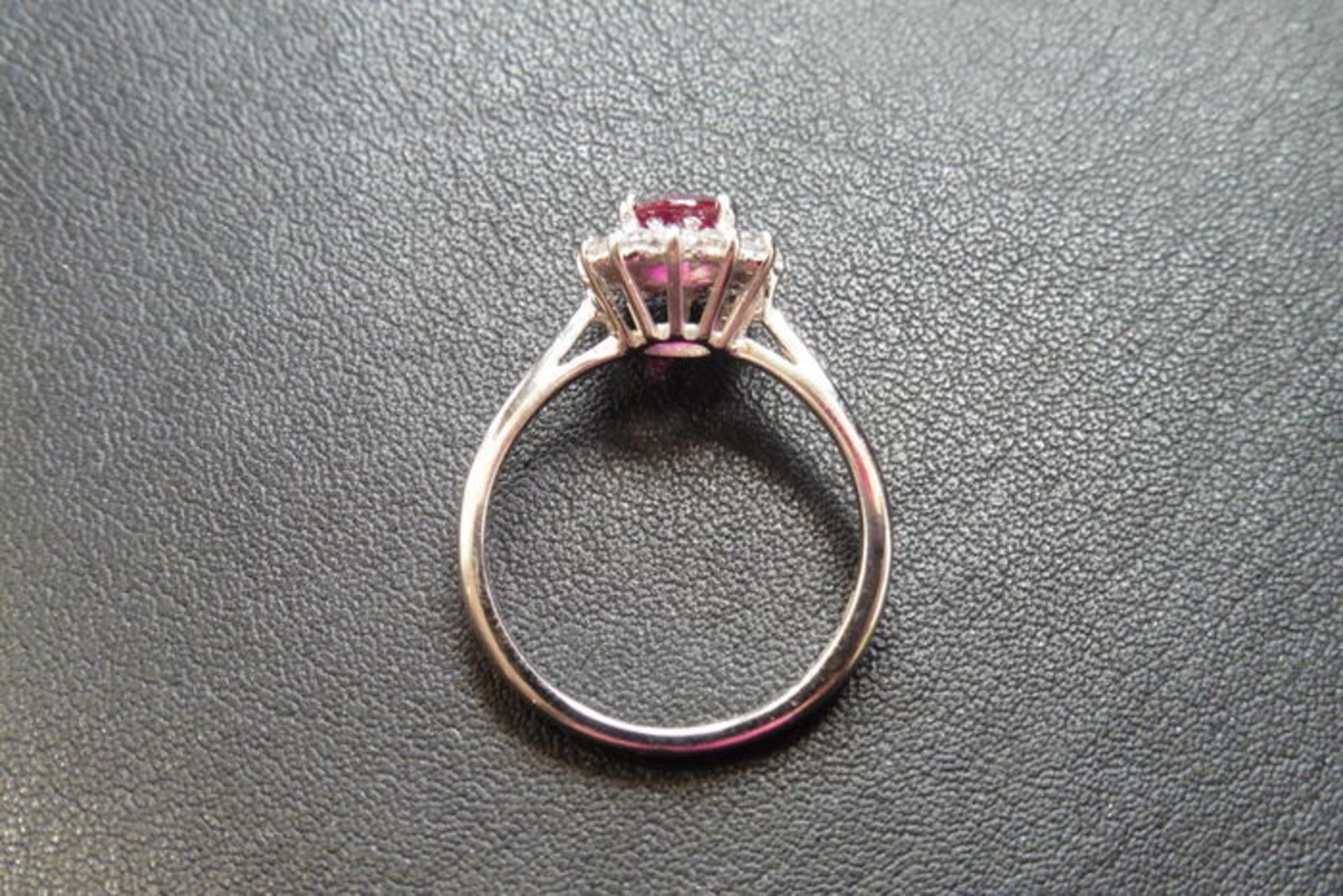 Ruby and diamond cluster style ring set in platinum. Oval cut ( treated ) ruby 0.80ct with 0.50ct of - Image 3 of 3