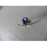 Tanzanite and diamond dress ring set in platinum. Oval cut tanzanite ( heat treated ) 2.40ct