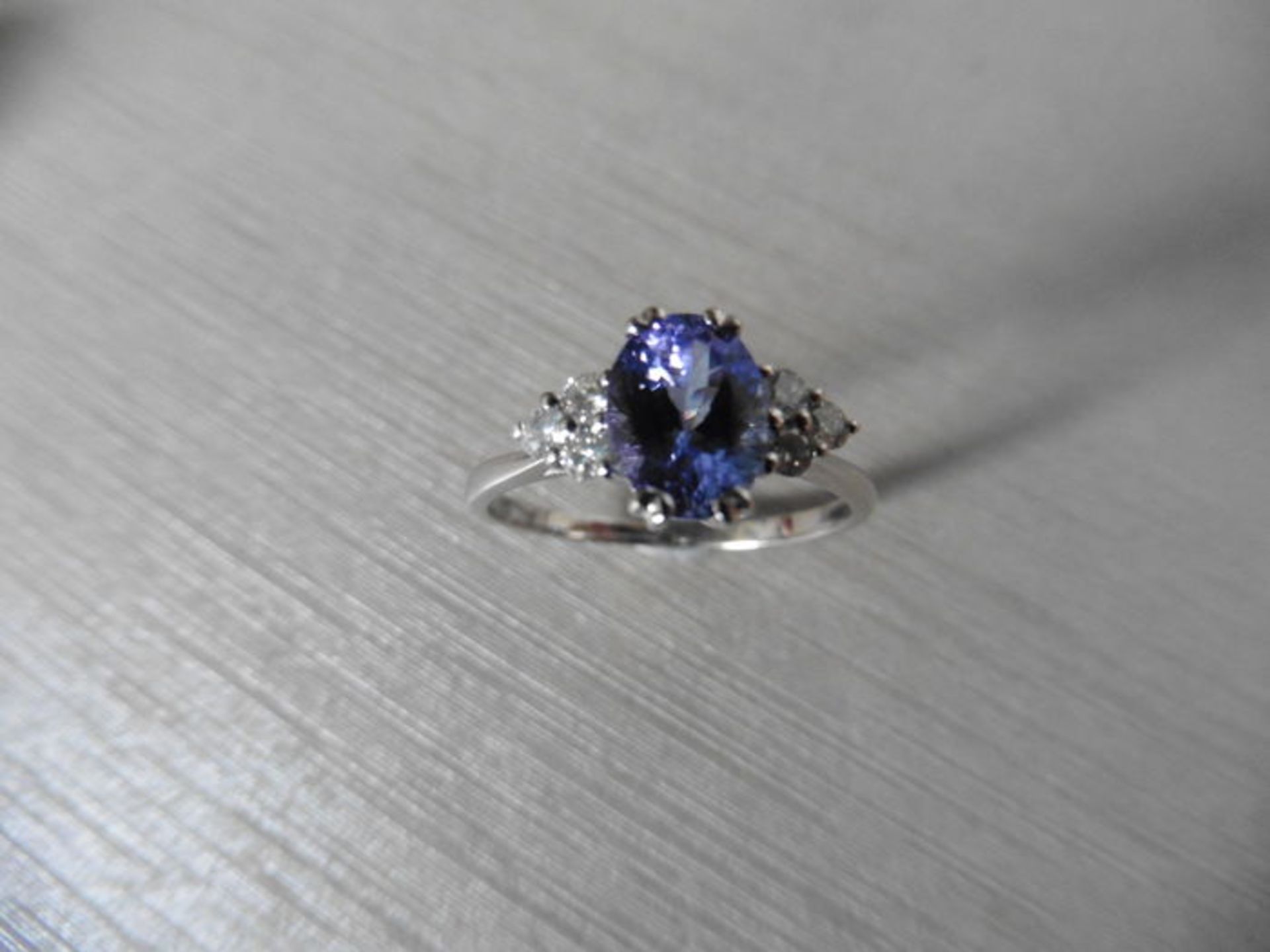 Tanzanite and diamond dress ring set in platinum. Oval cut tanzanite ( heat treated ) 2.40ct