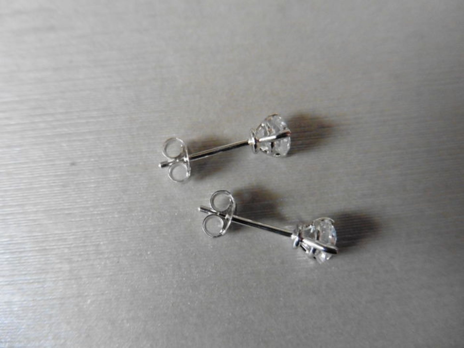 0.70ct diamond solitaire stud earrings set in platinum. I/J colour, si2 clarity.3 claw setting - Image 2 of 3