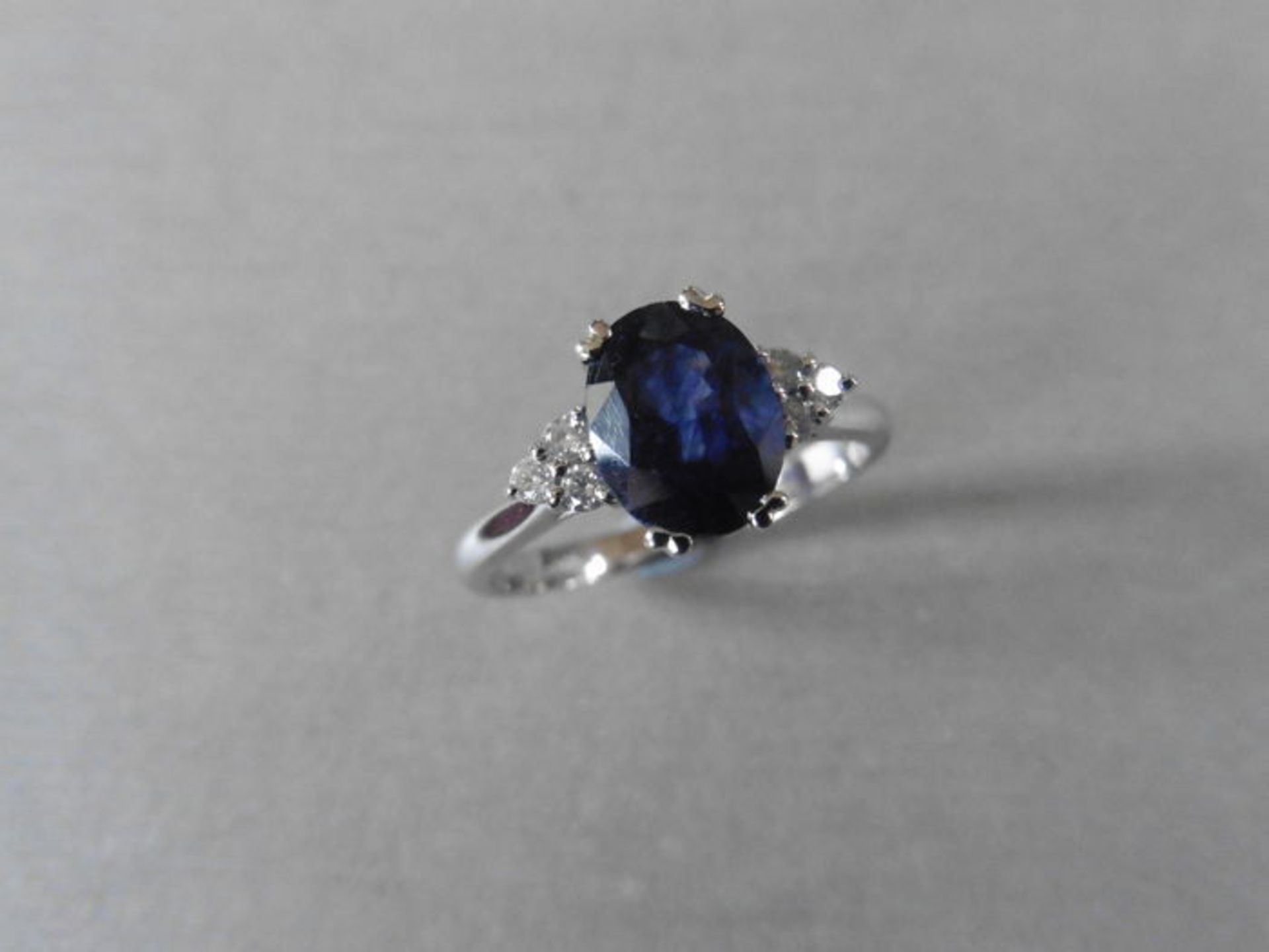 Sapphire and diamond dress ring set in platinum. Oval cut sapphire ( glass filled ) 2.40ct approx - Image 2 of 3