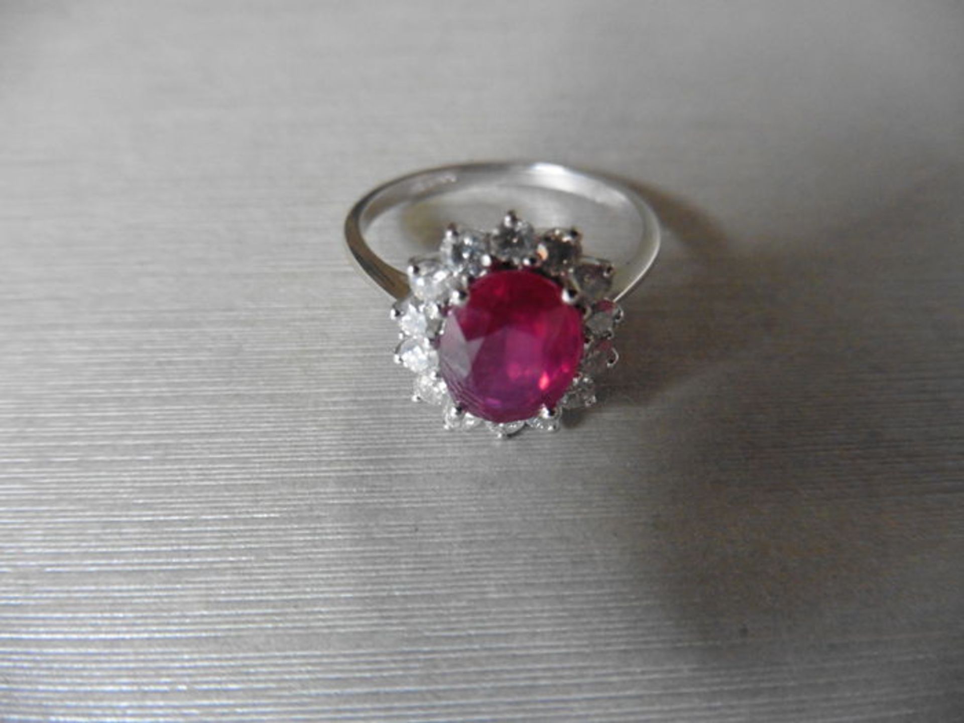 Ruby and diamond cluster style ring set in platinum. Oval cut ( glass filled ) ruby 2.50ct with 0. - Image 3 of 3