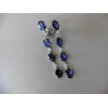 Sapphire and diamond drop style earrings set in platinum. Each set with 4 oval cut ( treated)