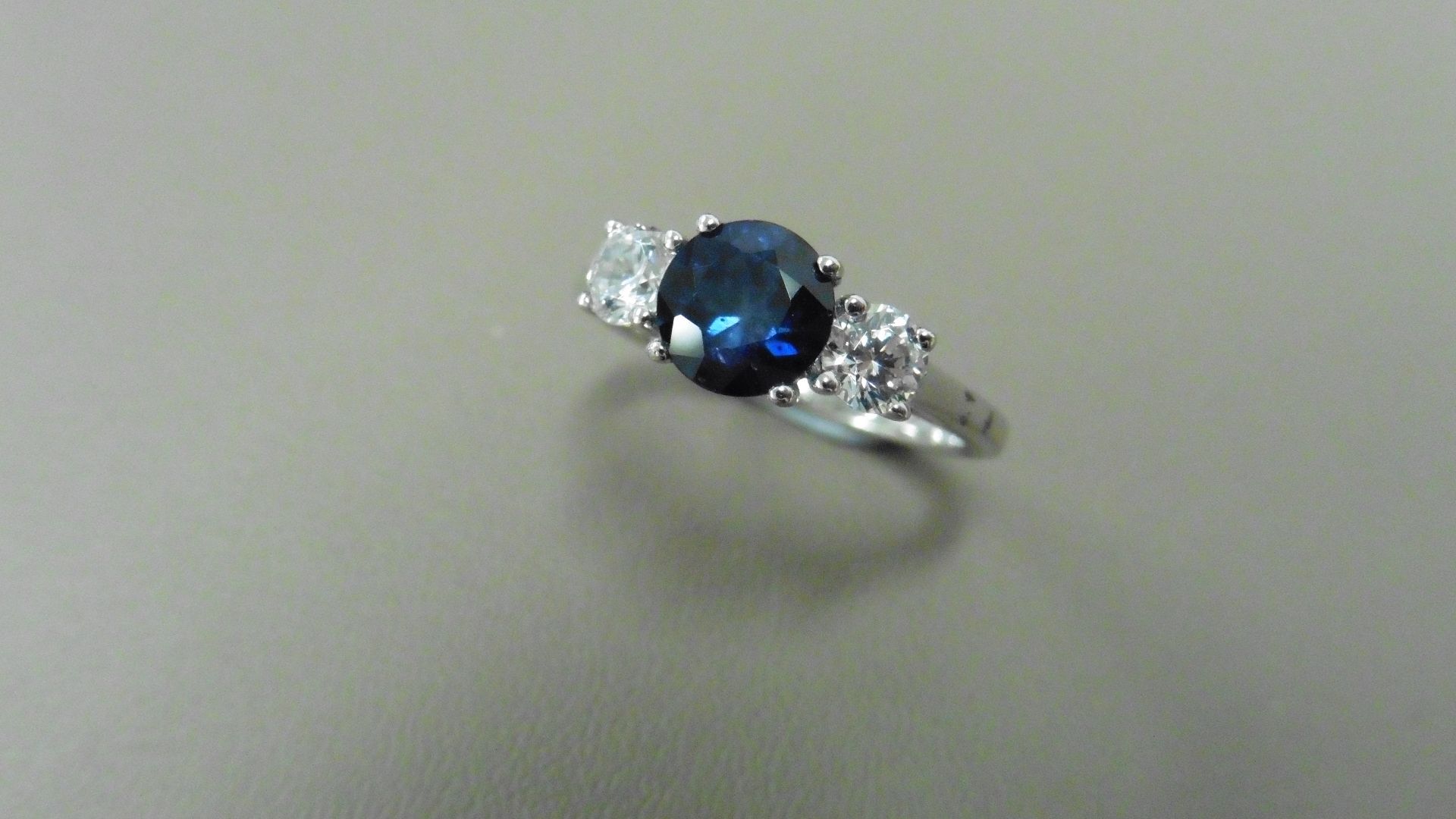 Sapphire and diamond trilogy ring. 5mm round cut sapphire ( treated ) with a brilliant cut diamond