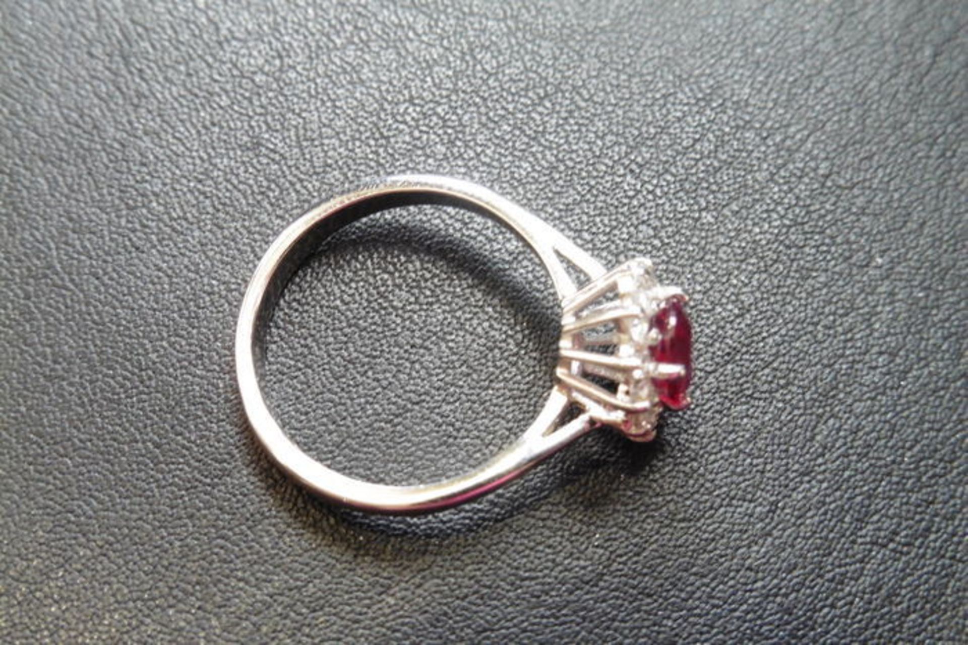 Ruby and diamond cluster style ring set in platinum. Oval cut ( treated ) ruby 0.80ct with 0.50ct of - Image 2 of 3