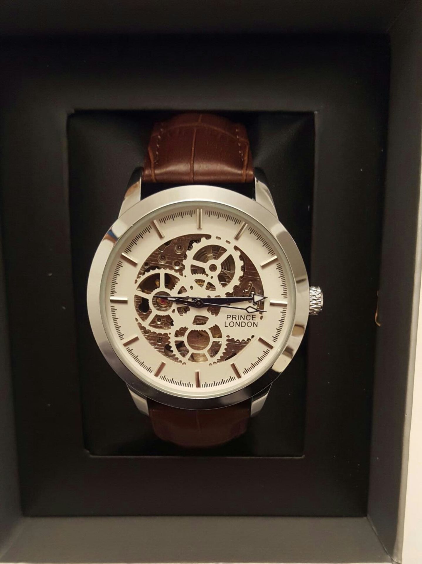 BRAND NEW PRINCE LONDON GENTS AUTOMATIC SKELETON WATCH, SILVER WITH SILVER/ WHITE ROUND FACE AND TAN