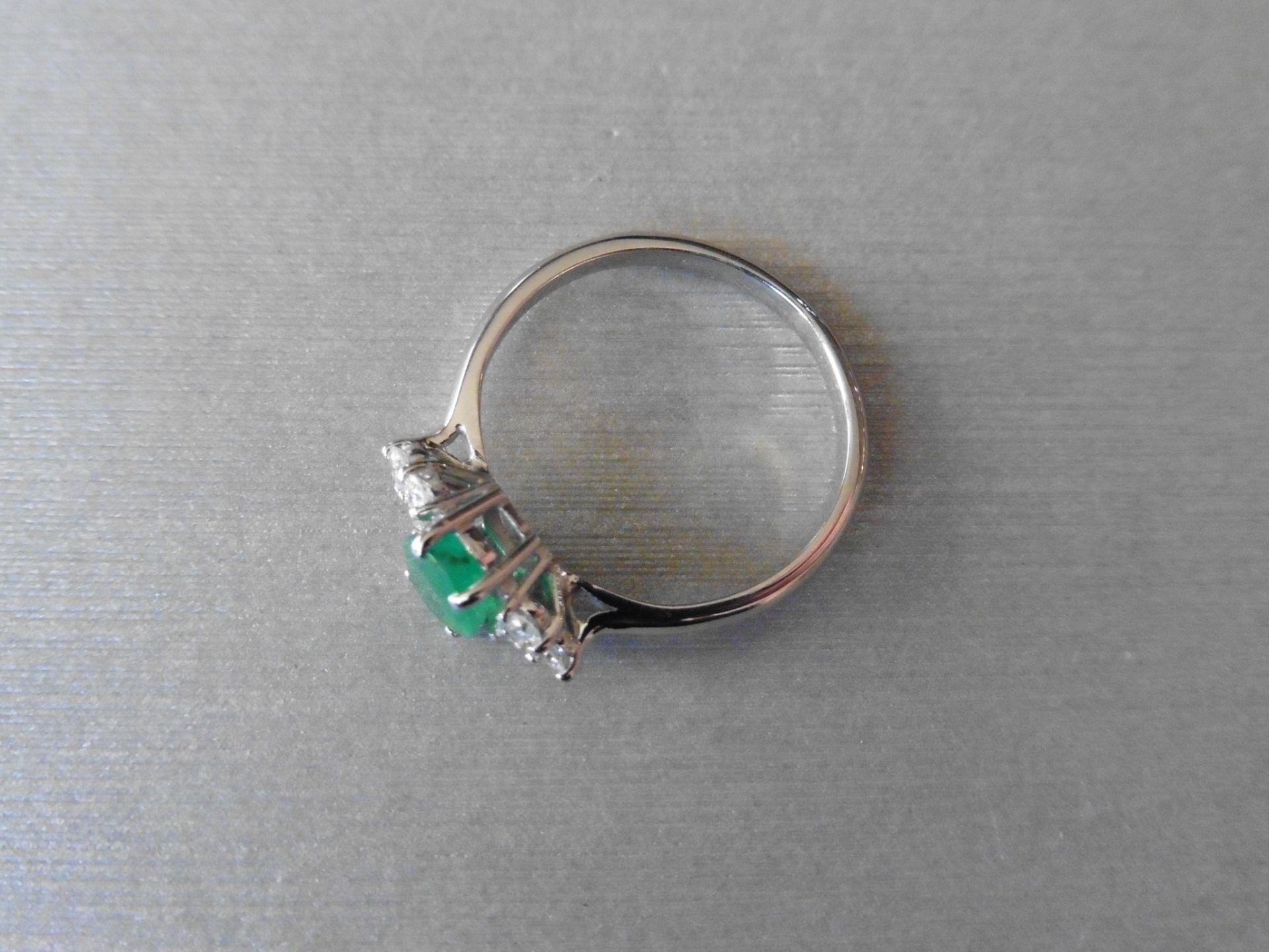 0.80ct emerald and diamond ring. Set with an oval cut emerald . Set either side are 3 small - Image 3 of 3
