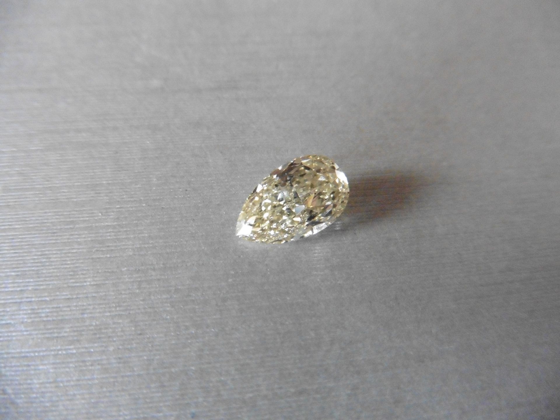 2.14ct single pear shaped diamond, fancy yellow, VVS1 clarity. Measures 11.05 x 6.70 x 4.08mm. HRD