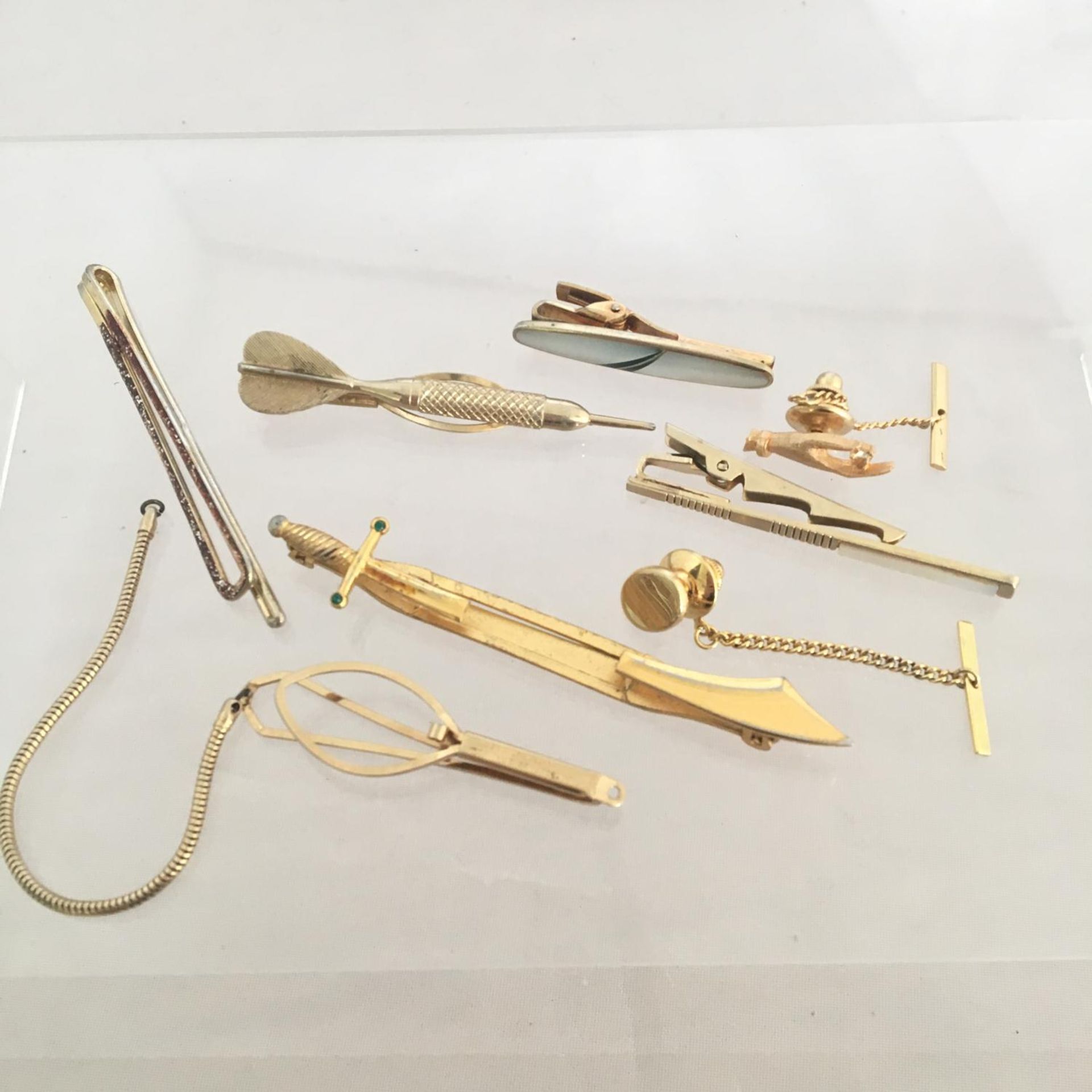 Various vintage tie clips and pins