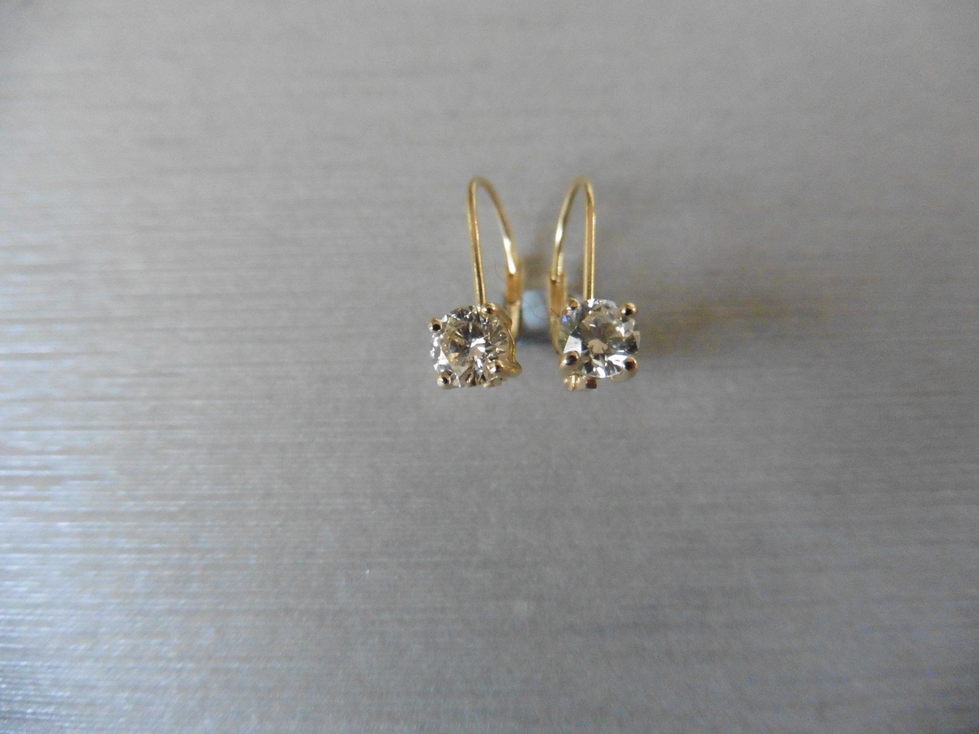 0.80ct diamond hinged style earrings each set with a brilliant cut diamond, I colour, si2 clarity.