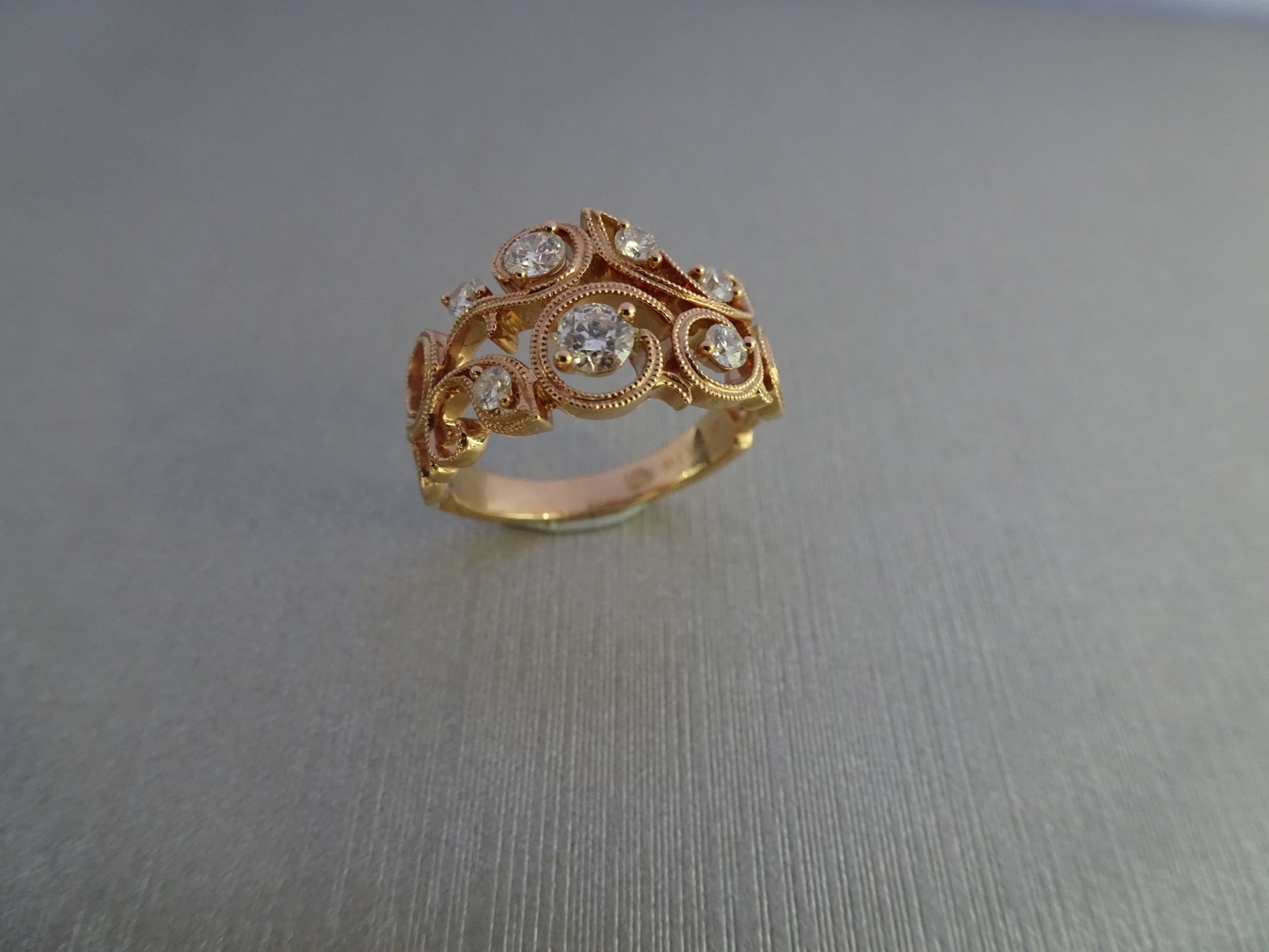 0.46ct 14ct rose gold open diamond dress ring. Set with graduated Brilliant cut diamonds, of H