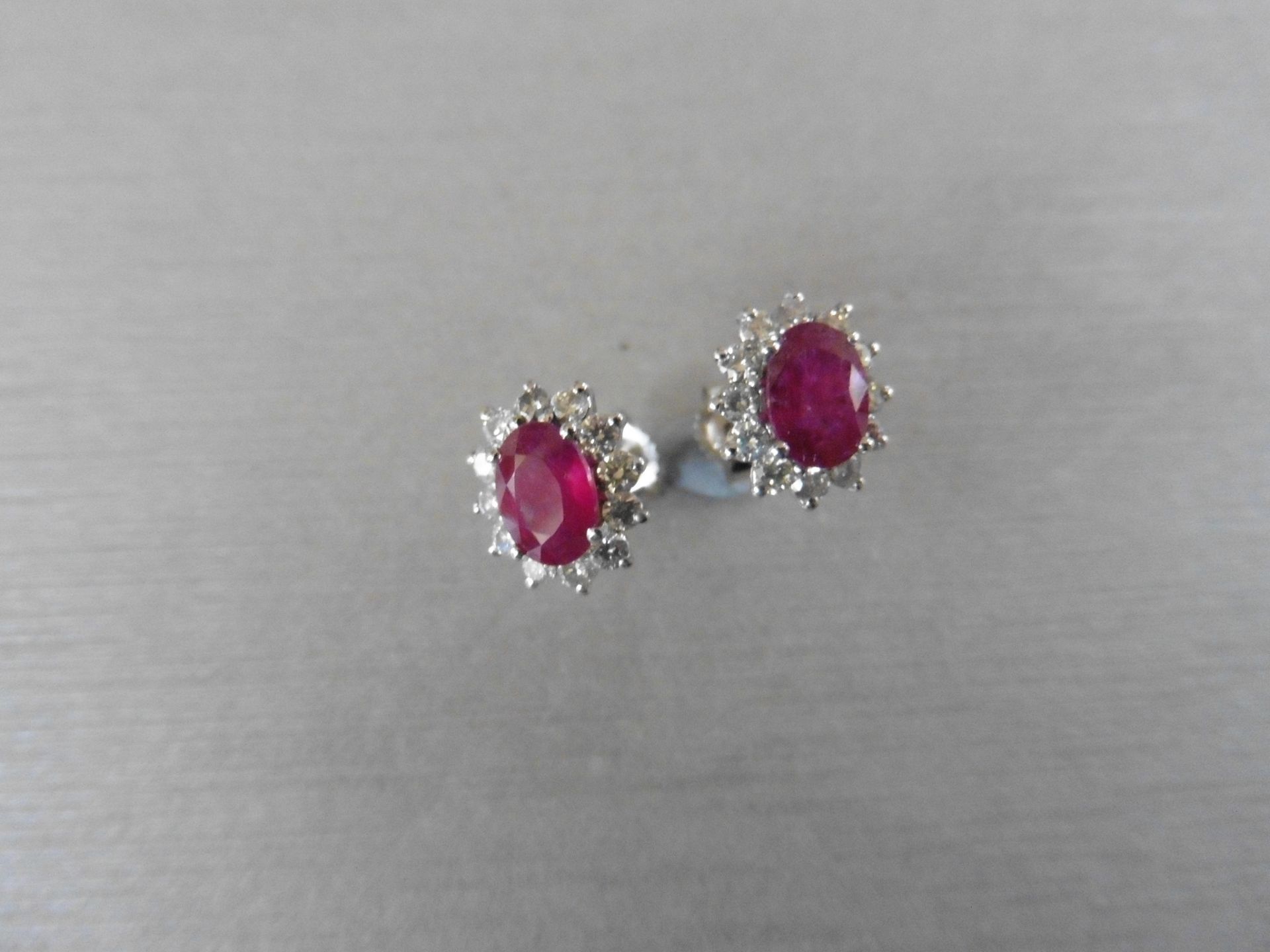 1.60ct ruby and Diamond cluster style stud earrings. Each ruby measures 7mm x 5mm and is