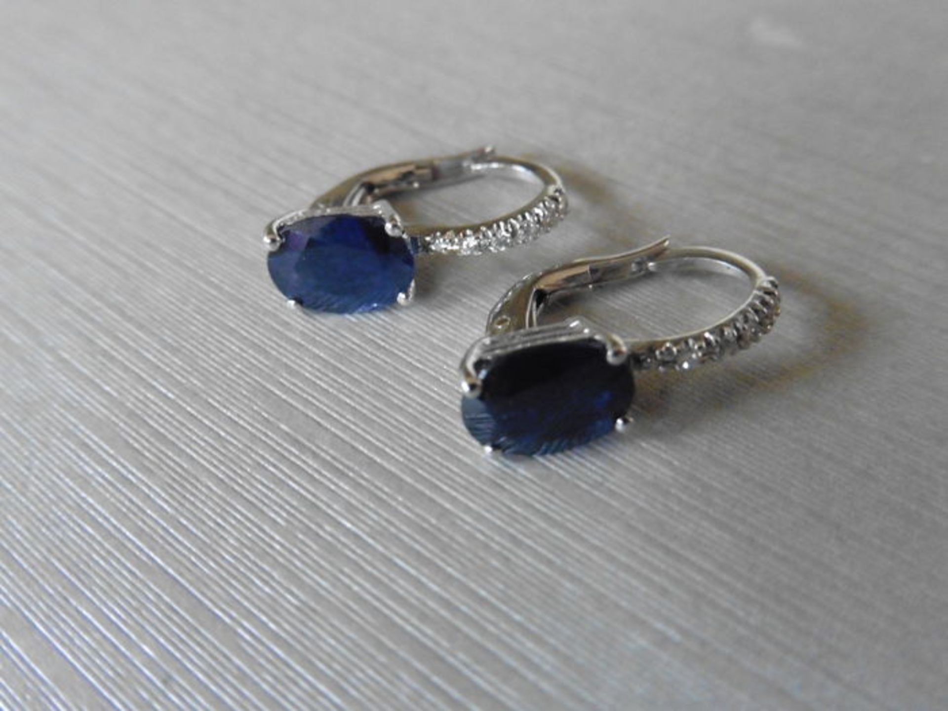 1.60ct sapphire and diamond hoop style earrings. Each is set with a 7x 5mm oval cut sapphire with - Image 4 of 4