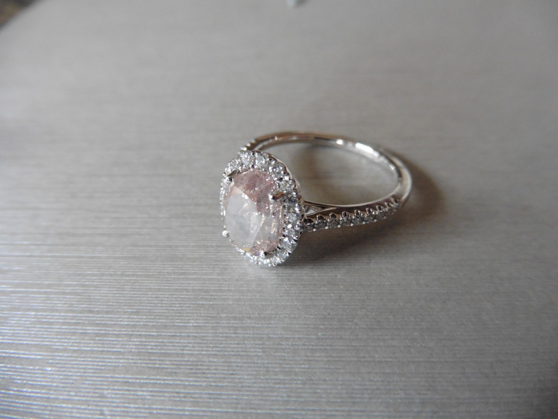 2.35ct diamond set ring with a 2ct pink/ brown oval shaped diamond. This is surrounded with a halo - Image 3 of 5