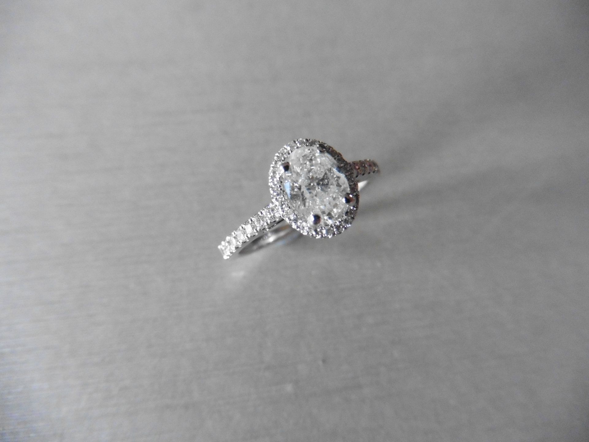 0.84ct oval diamond set solitaire ring. Centre diamond G/H colour, Si3 clarity. Halo setting of