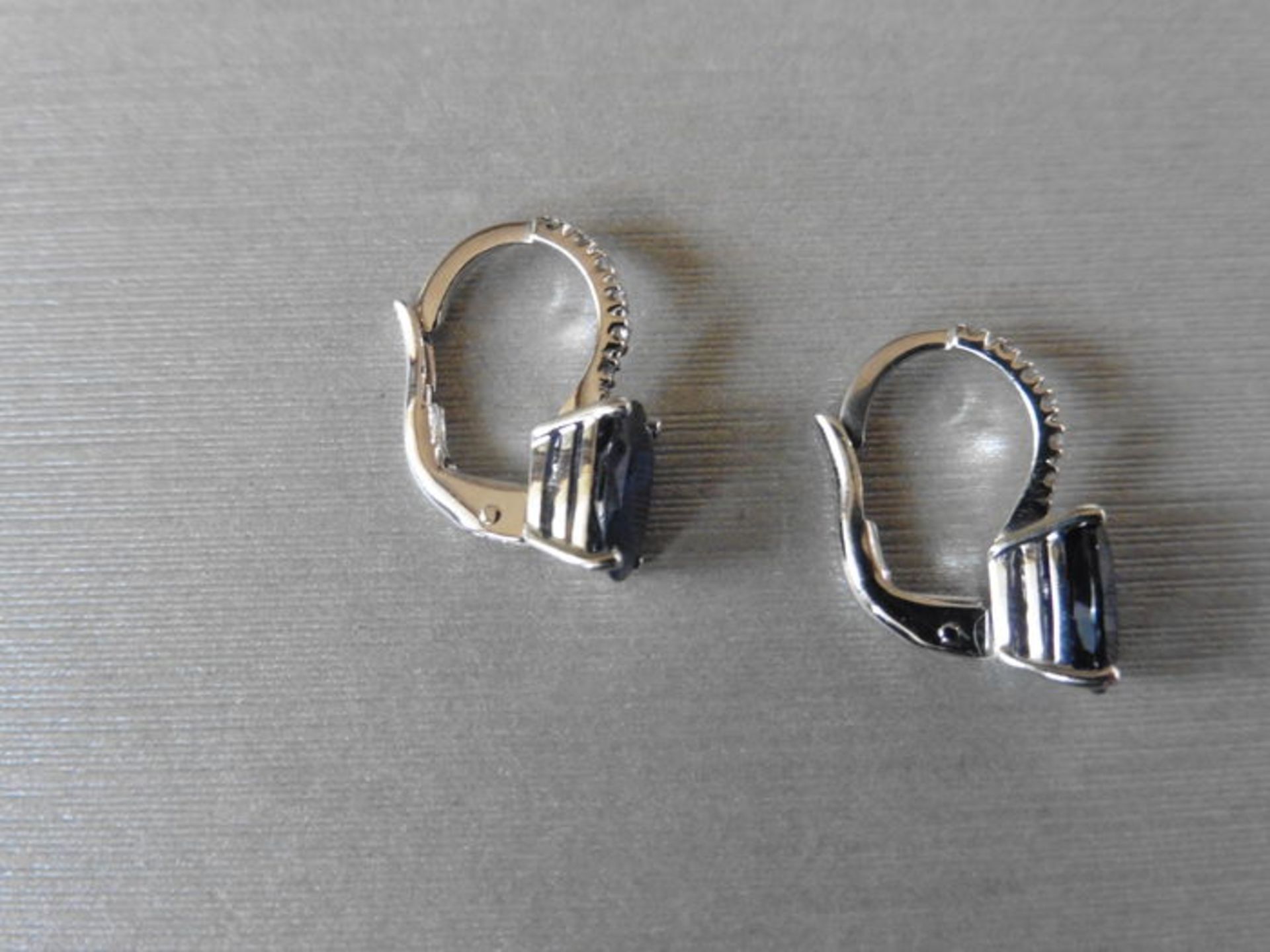 1.60ct sapphire and diamond hoop style earrings. Each is set with a 7x 5mm oval cut sapphire with - Image 2 of 4