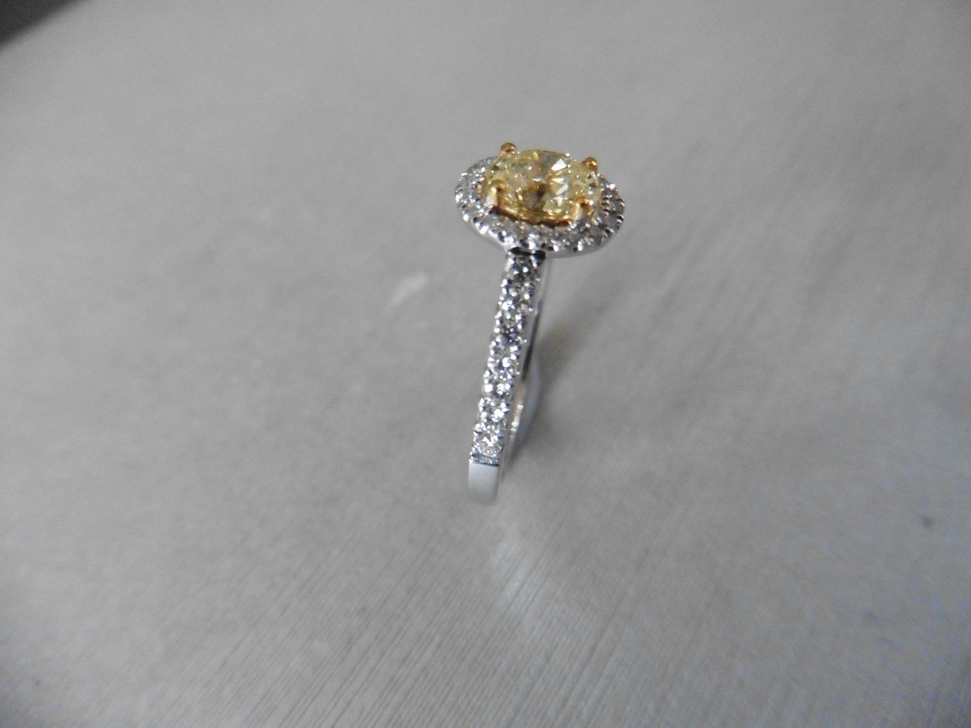 0.40ct yellow oval diamond set solitaire ring with a halo setting of brilliant cut diamonds, H - Image 4 of 4