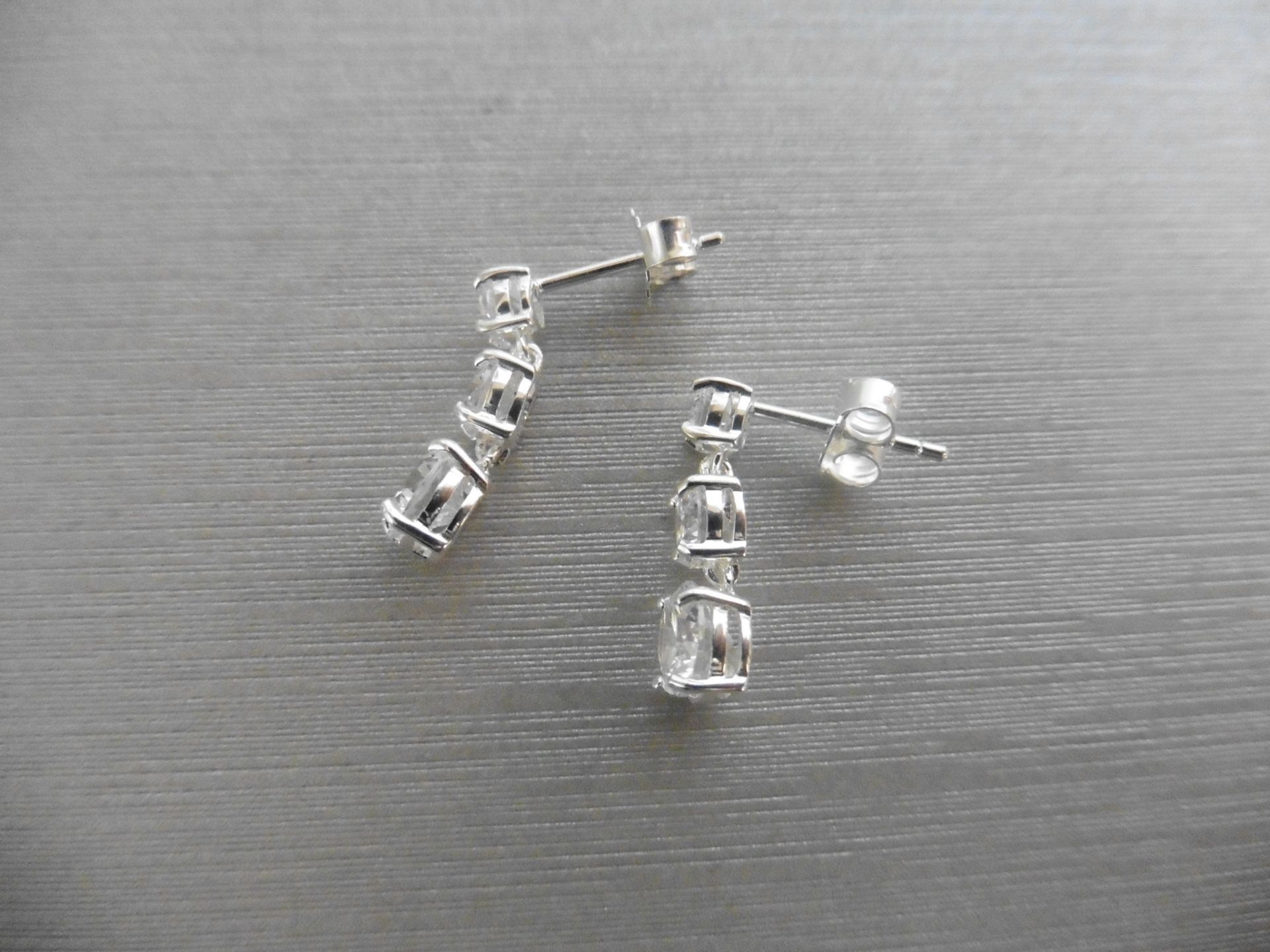 1.00ct diamond trilogy drop earrings. Each is set with 3 graduated brilliant cut diamonds, Si2 - Image 2 of 3