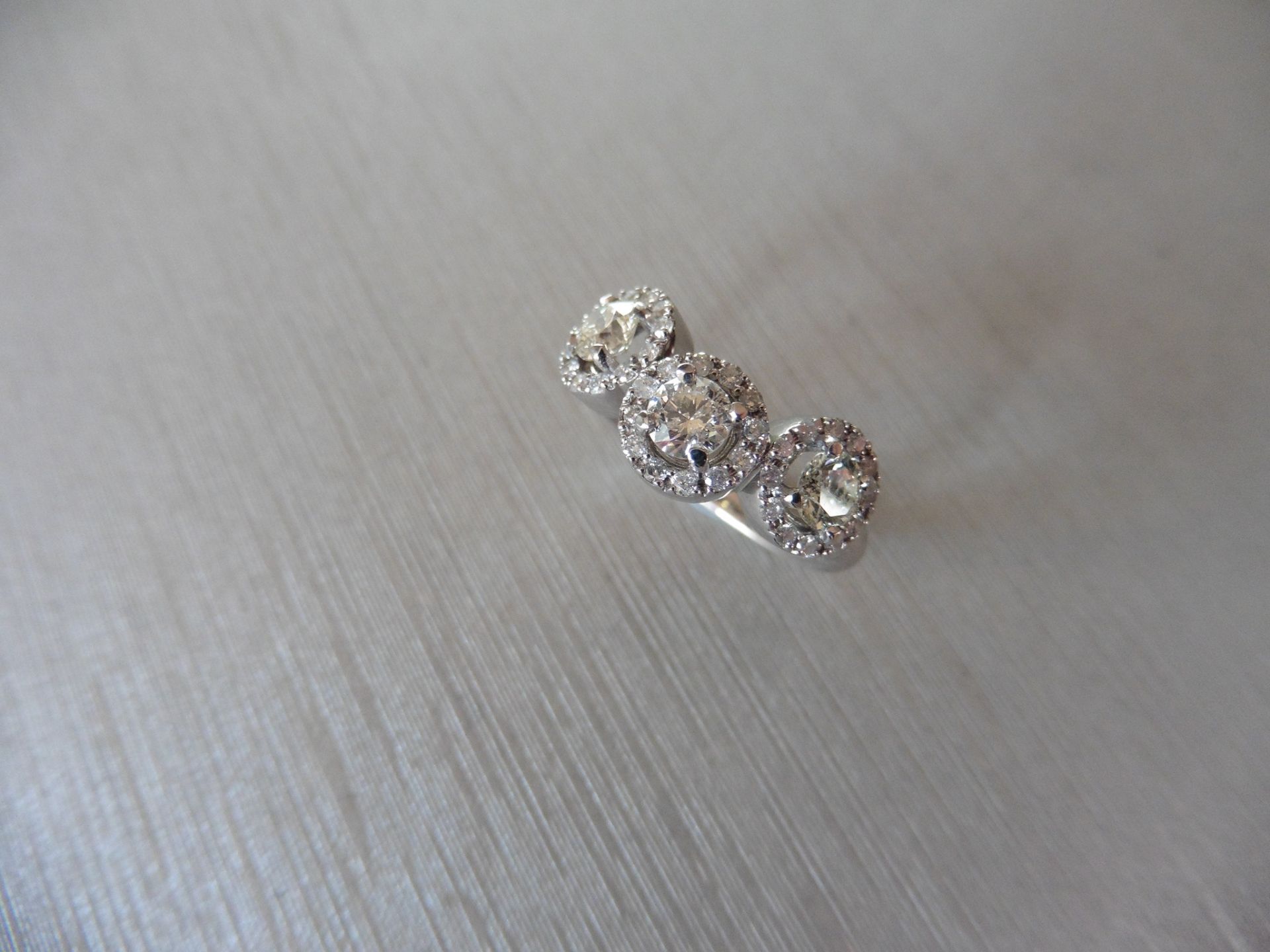 1.03ct diamond halo set trilogy style dress ring. Set with 3 centred brilliant cut diamonds, I - Image 4 of 5