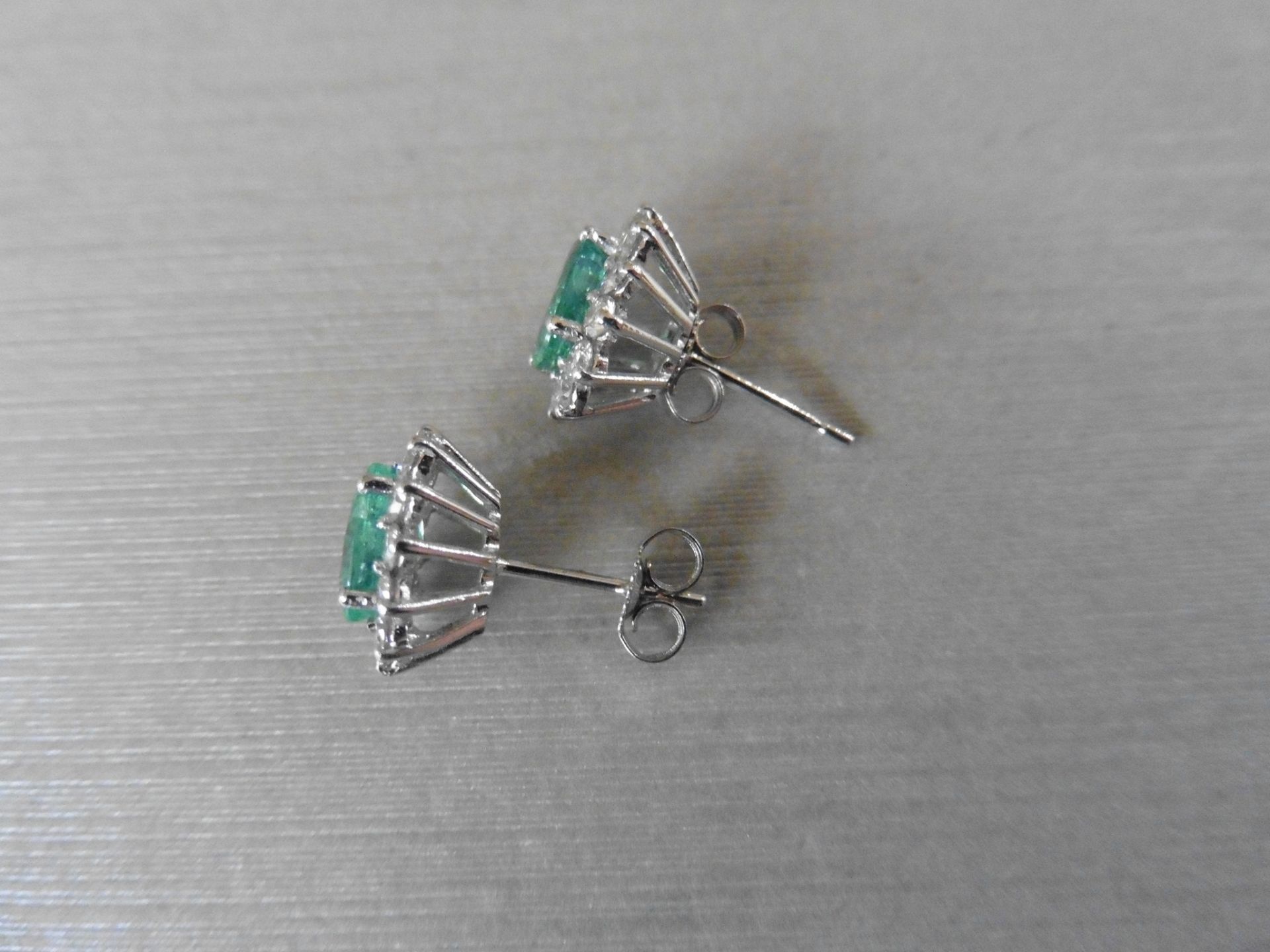 1.60ct emerald and Diamond cluster style stud earrings. Each emerald measures 7mm x 5mm and is - Image 3 of 4