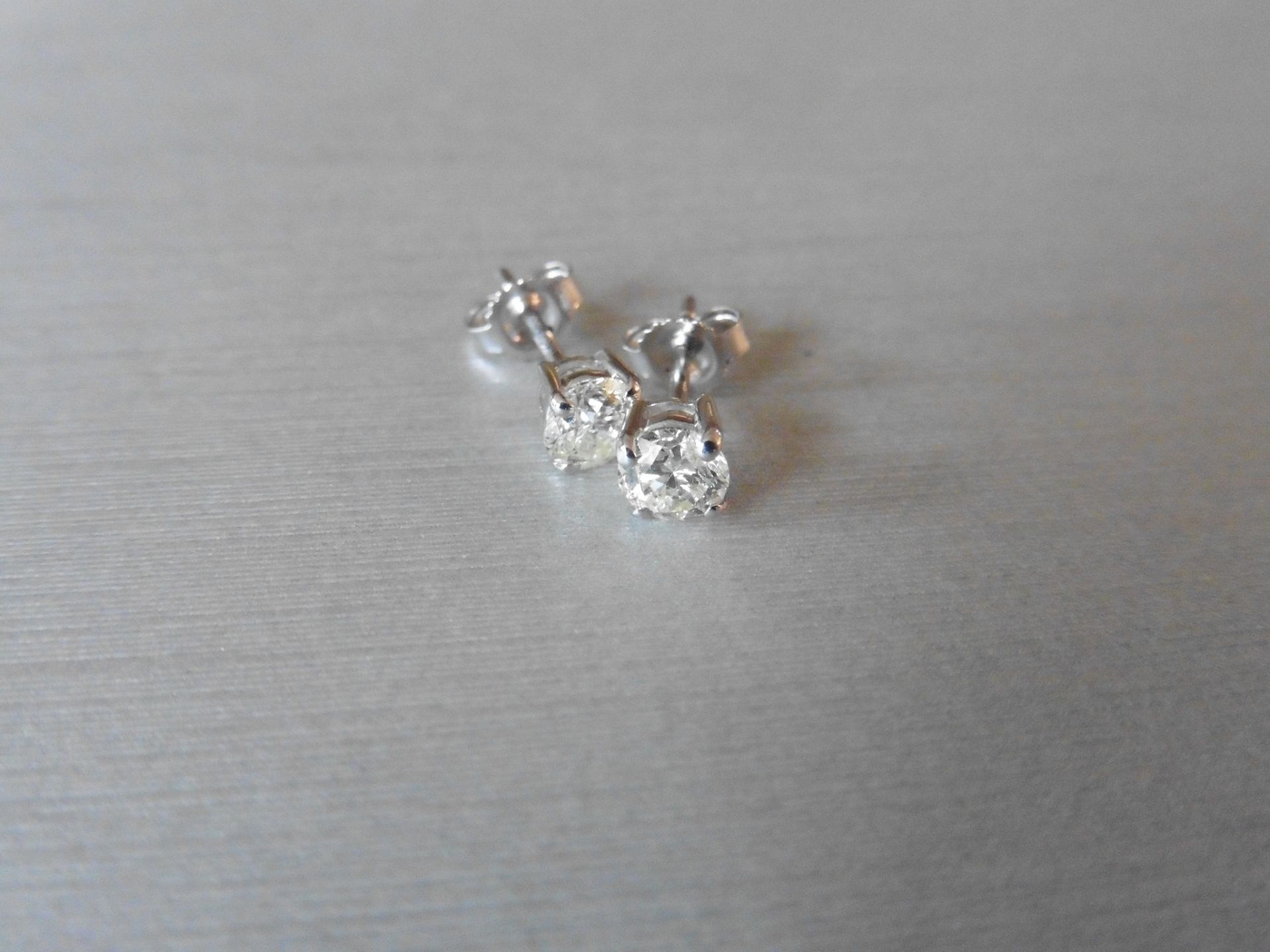 0.90ct Solitaire diamond stud earrings set with brilliant cut diamonds. SI2 clarity and I colour.