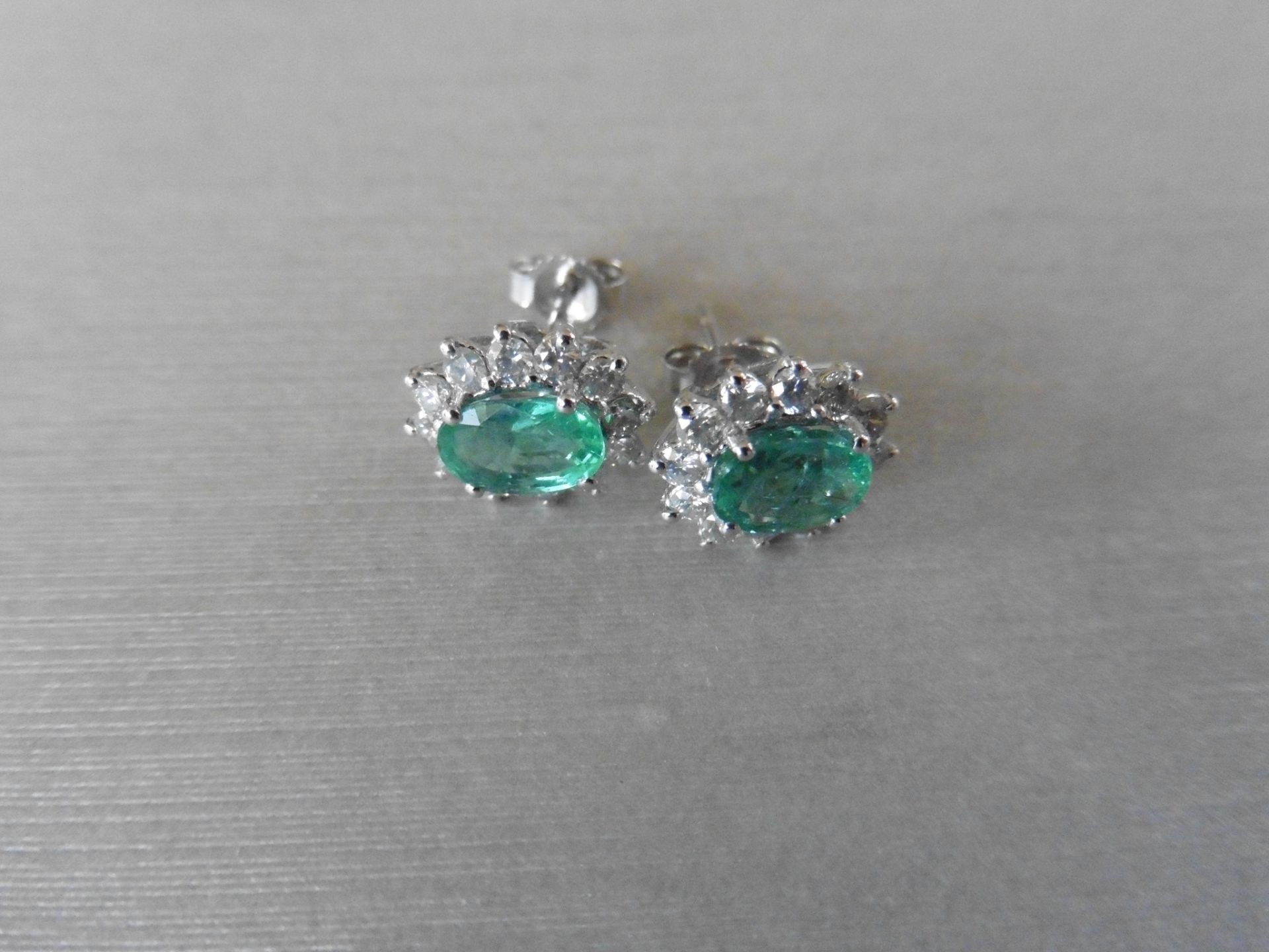 1.60ct emerald and Diamond cluster style stud earrings. Each emerald measures 7mm x 5mm and is - Image 2 of 4