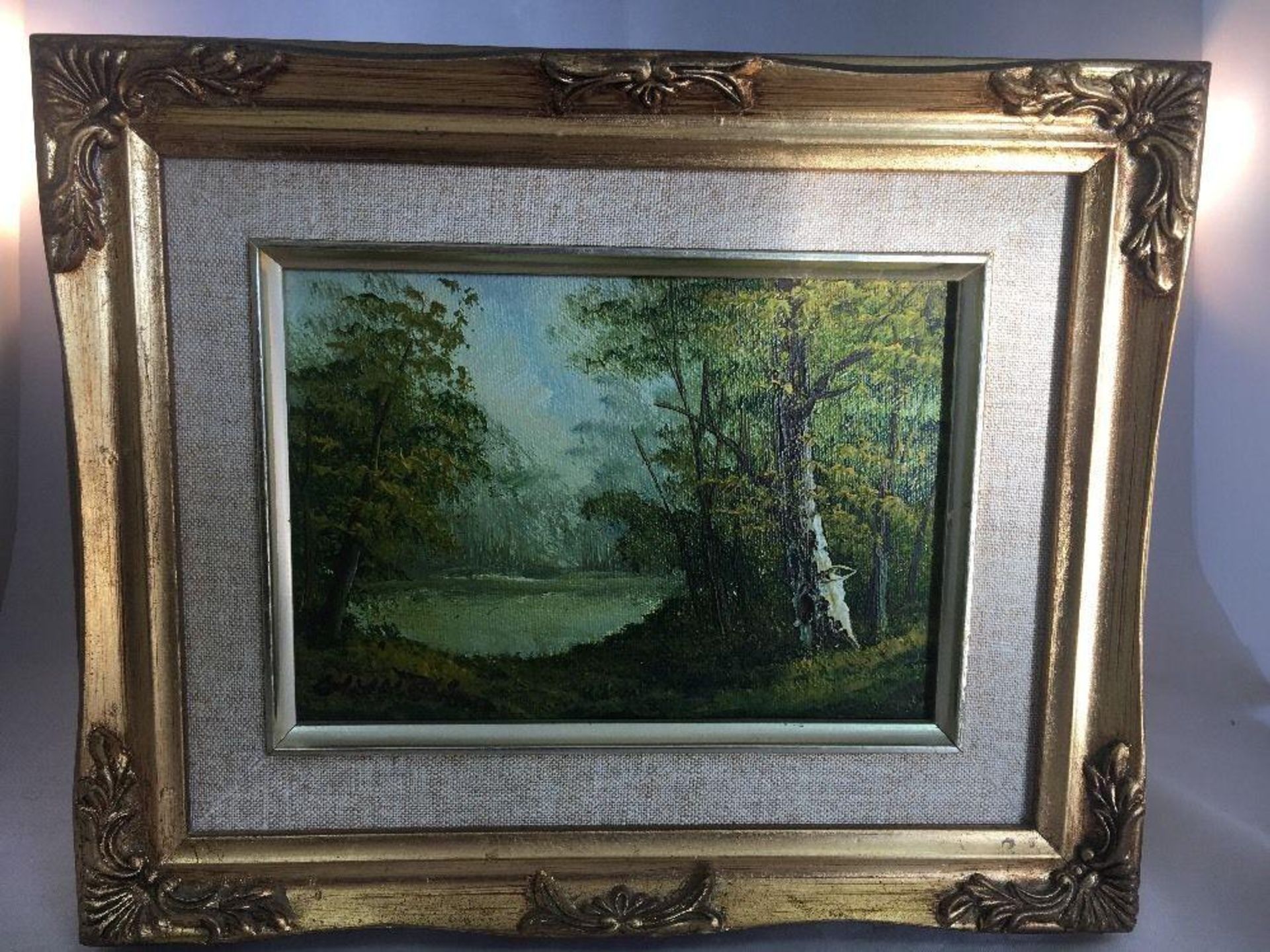 C. INNESS (1874 - 1932) FRAMED OIL PAINTING OF COUNTRY LANDSCAPE. The hammer price includes free