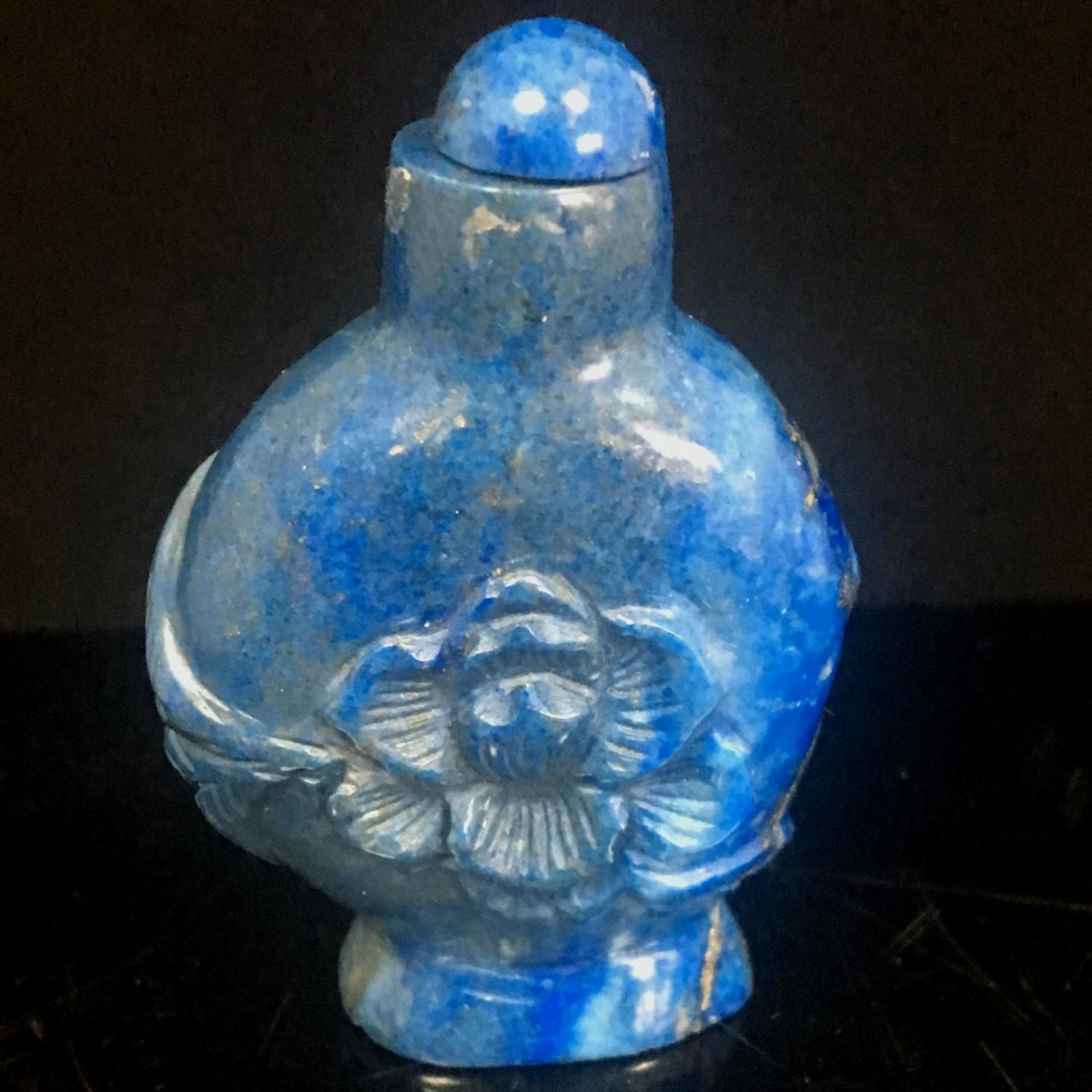 Antique Chinese natural hand-carved lapis lazuli snuff bottle. The carving depicts a lotus flower.