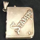 VINTAGE NOVELTY SILVER STAMP HOLDER PENDANT. In the form of a book with swivel out stamp holding